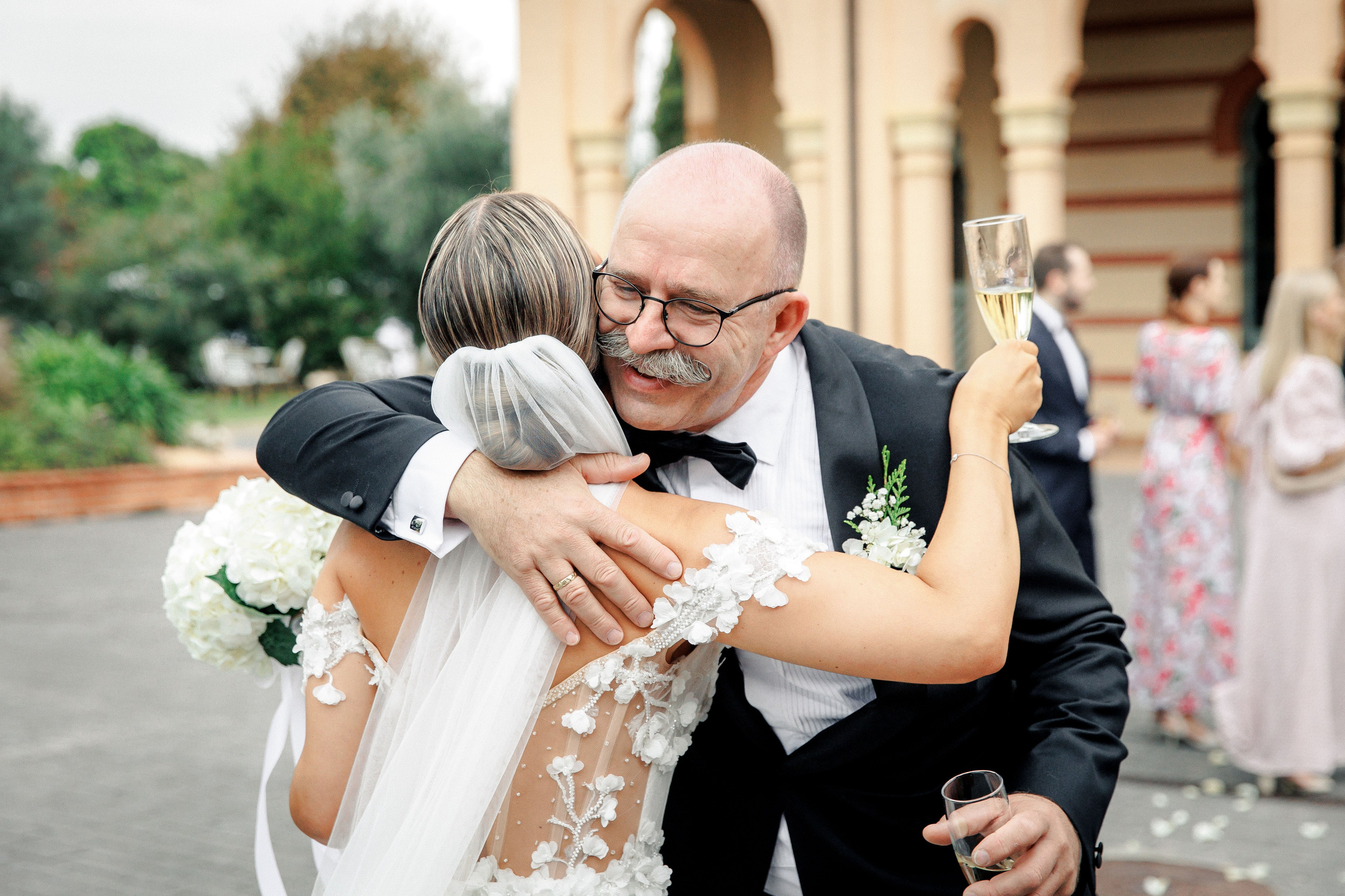 The bride shares a joyful moment with her father after the wedding ceremony in Barcelona.