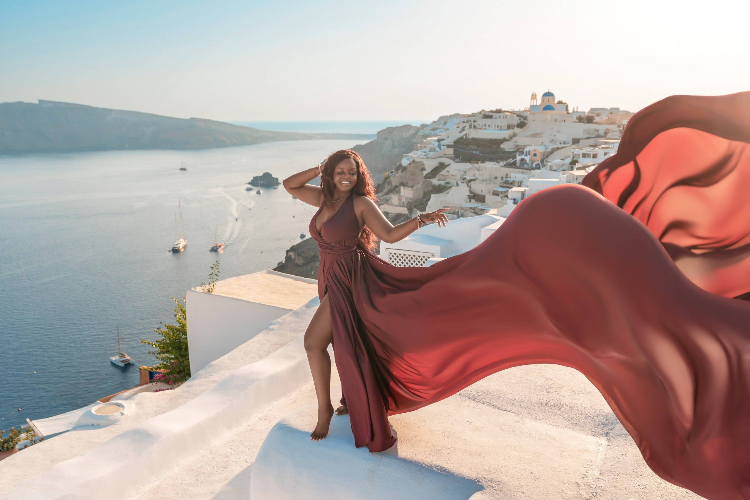 Unique Photoshoot Location in Santorini: Oia Finikia. Photographer in Santorini SokoLOVE Alex| Flying Dress Santorini