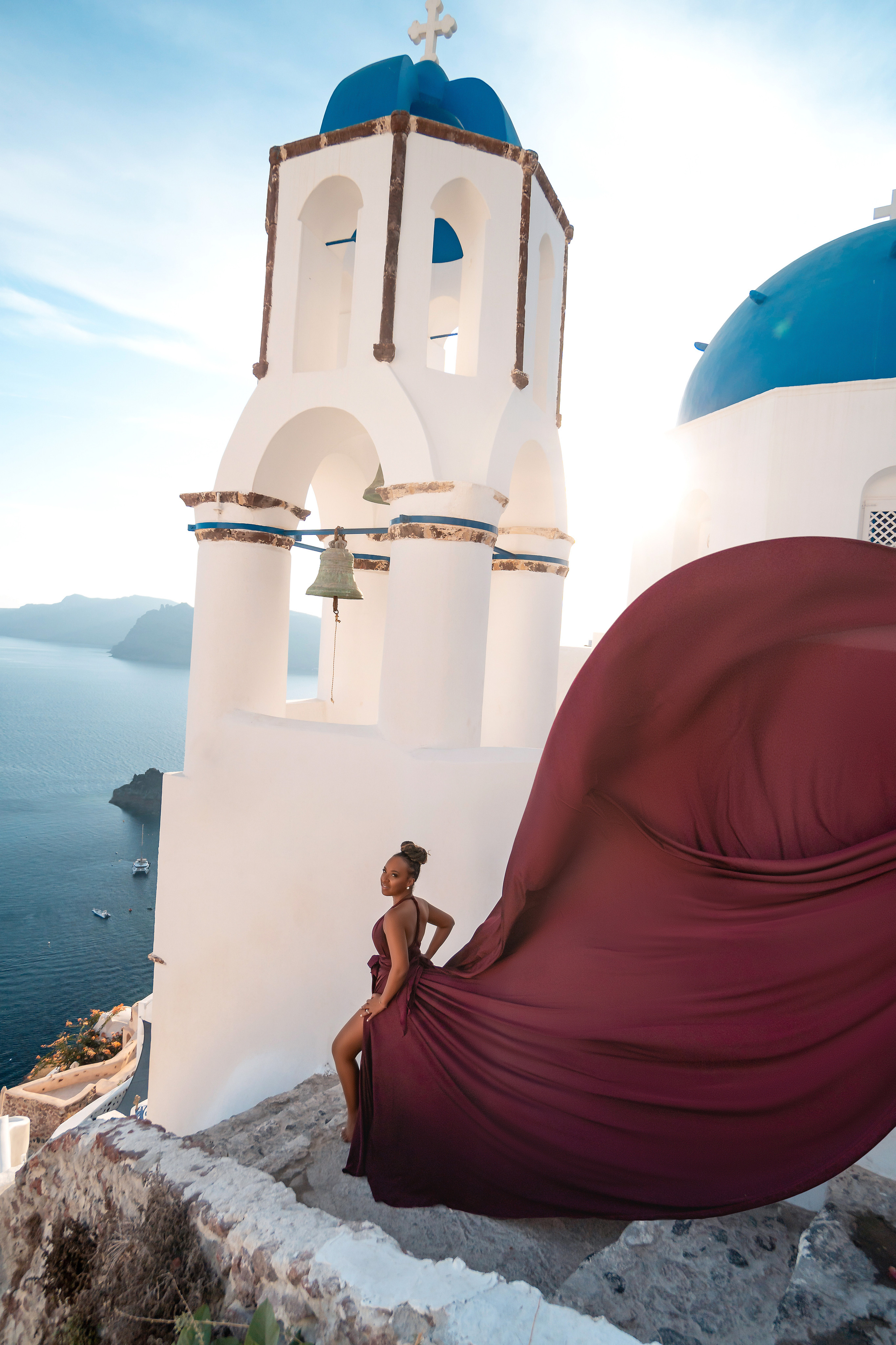 Photo session in Oia, Santorini at sunset, cherry flying dress. Photographer in Santorini SokoLOVE Alex| Flying Dress Santorini