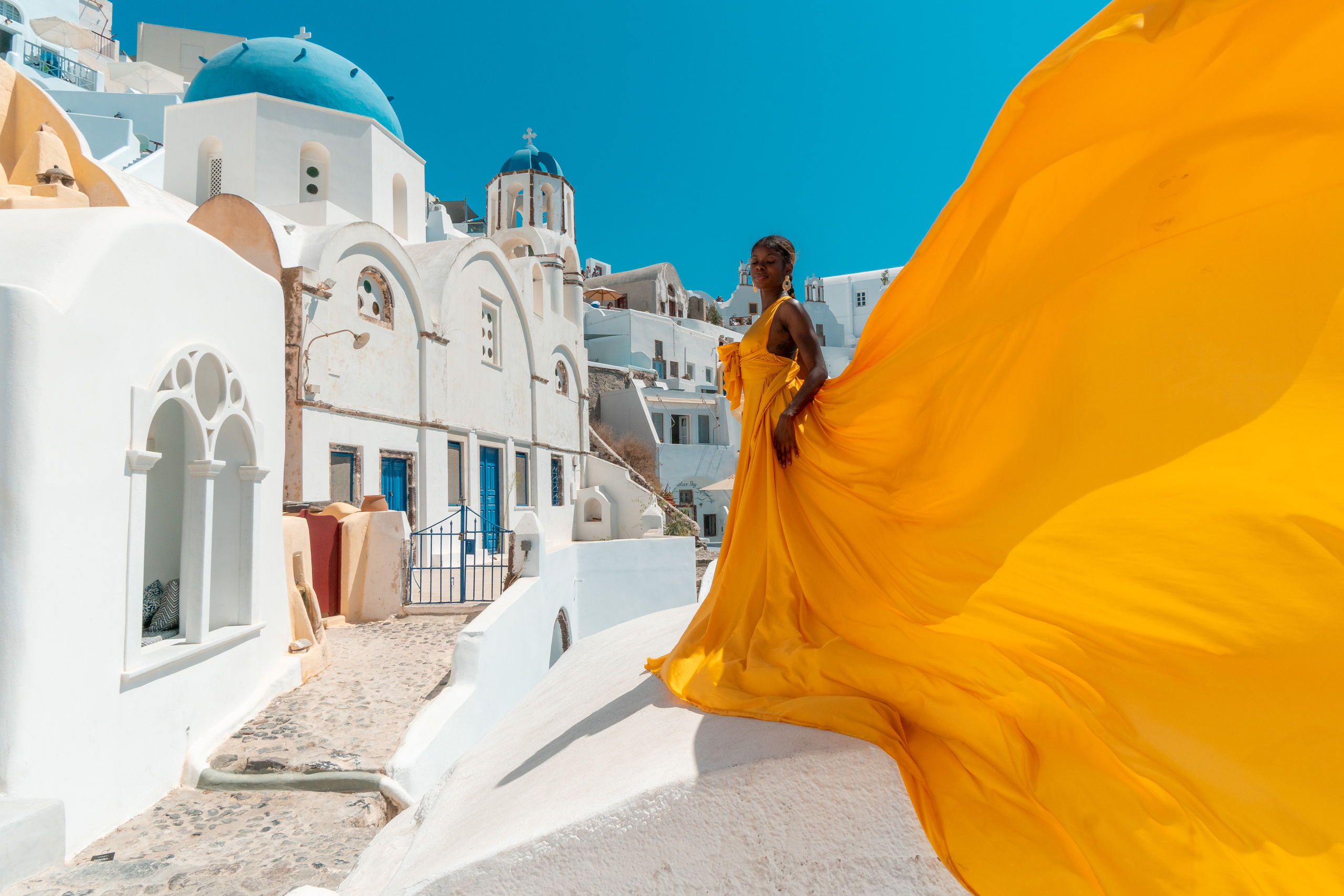 Yellow flying dress photo in Santorini