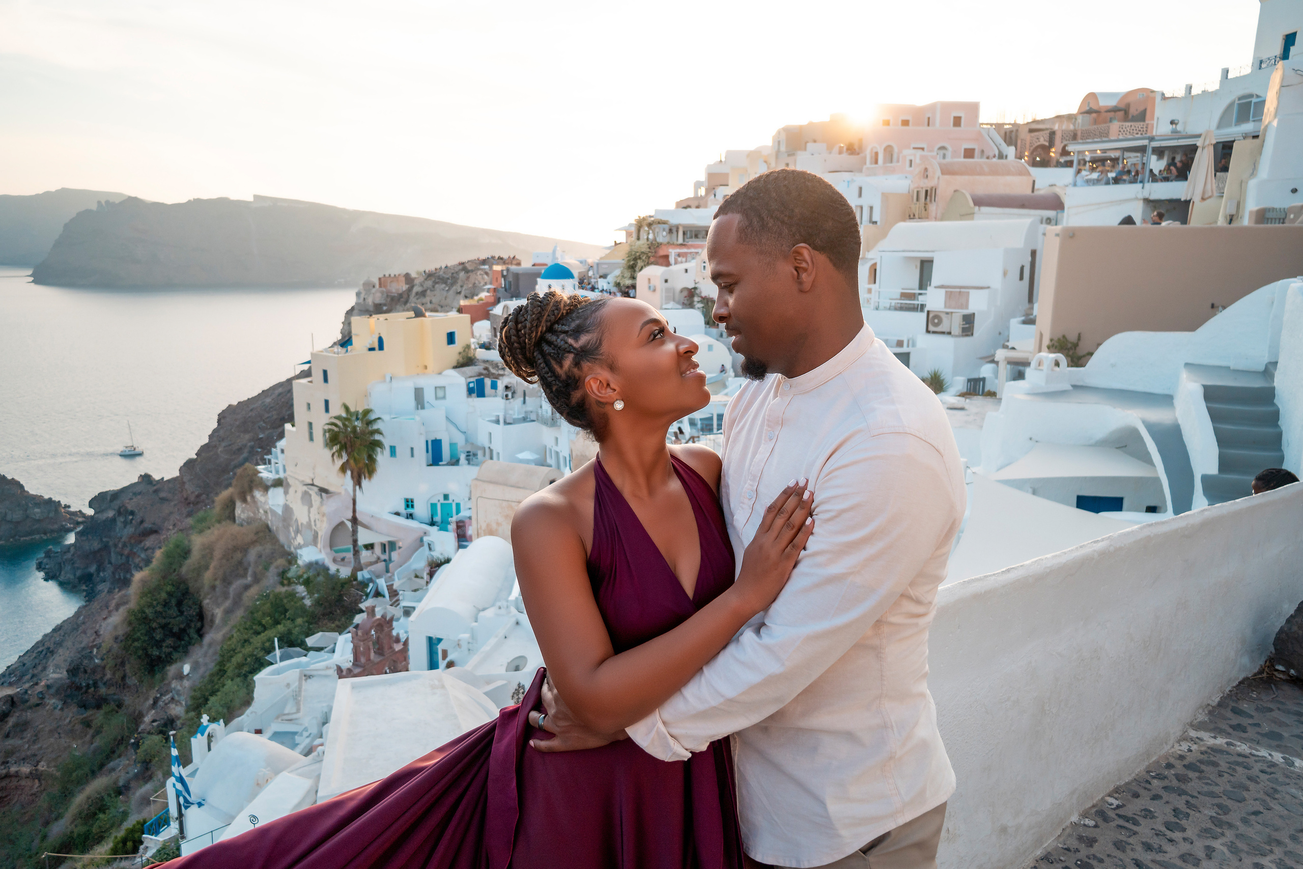 Photo session in Oia, Santorini at sunset, cherry flying dress. Photographer in Santorini SokoLOVE Alex| Flying Dress Santorini