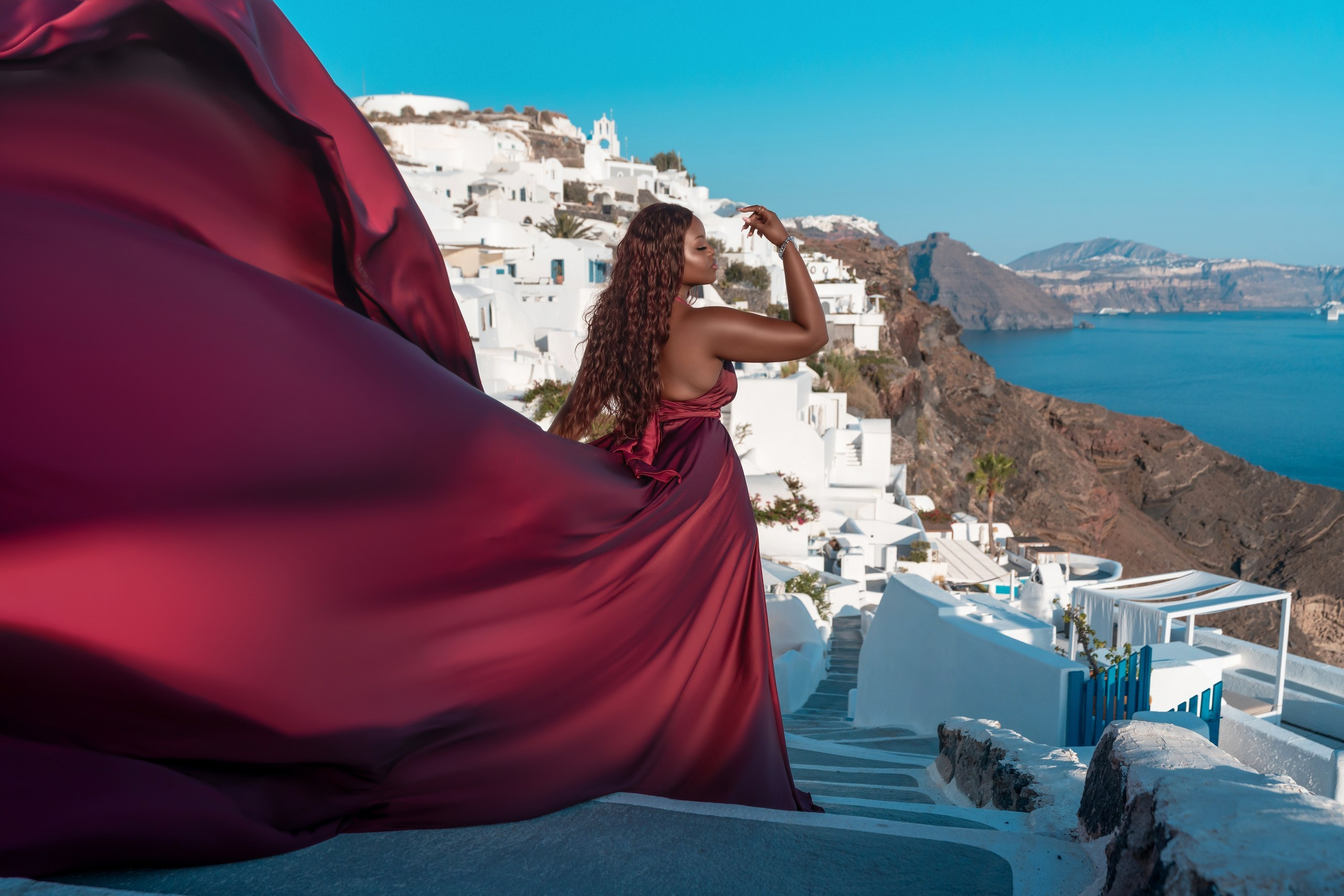 Unique Photoshoot Location in Santorini: Oia Finikia. Photographer in Santorini SokoLOVE Alex| Flying Dress Santorini