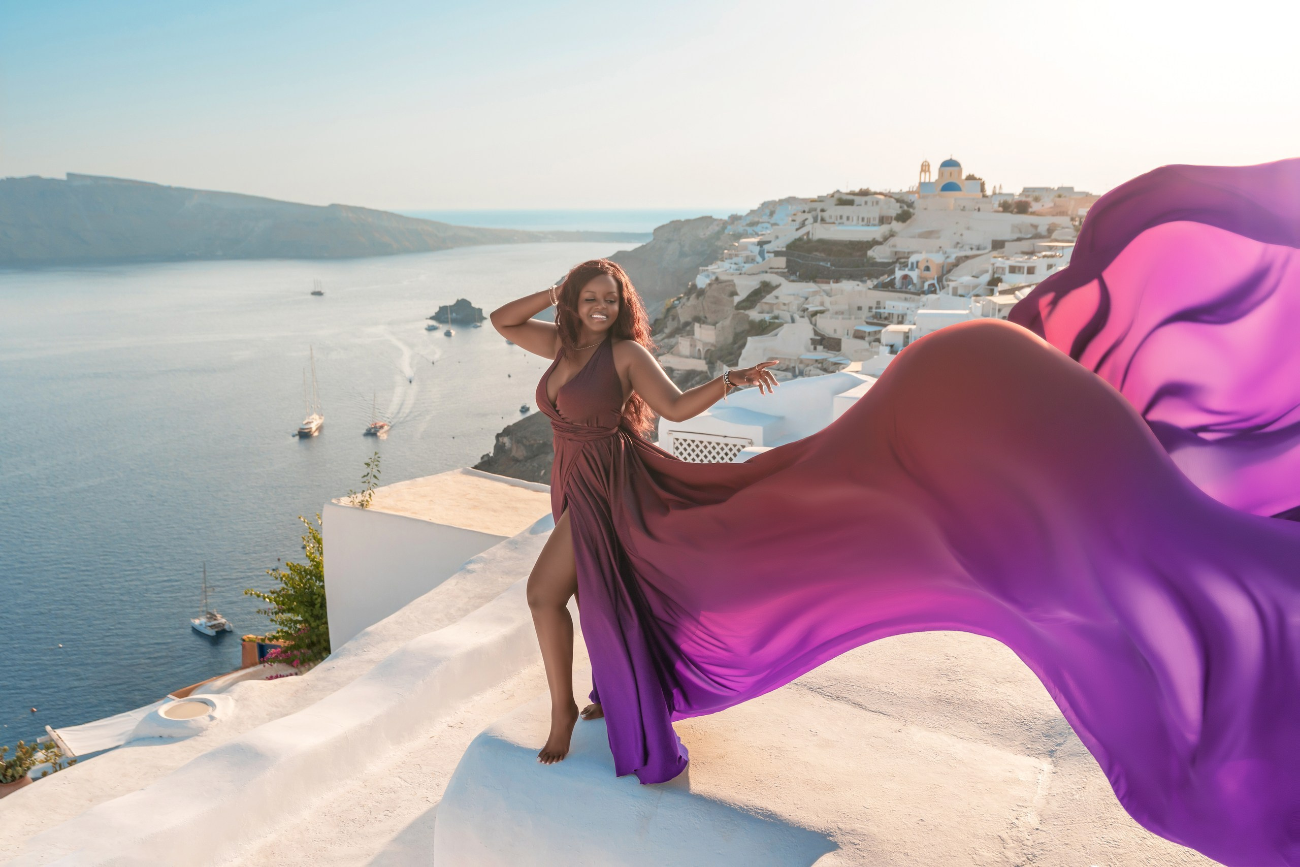 Unique Photoshoot Location in Santorini: Oia Finikia. Photographer in Santorini SokoLOVE Alex| Flying Dress Santorini