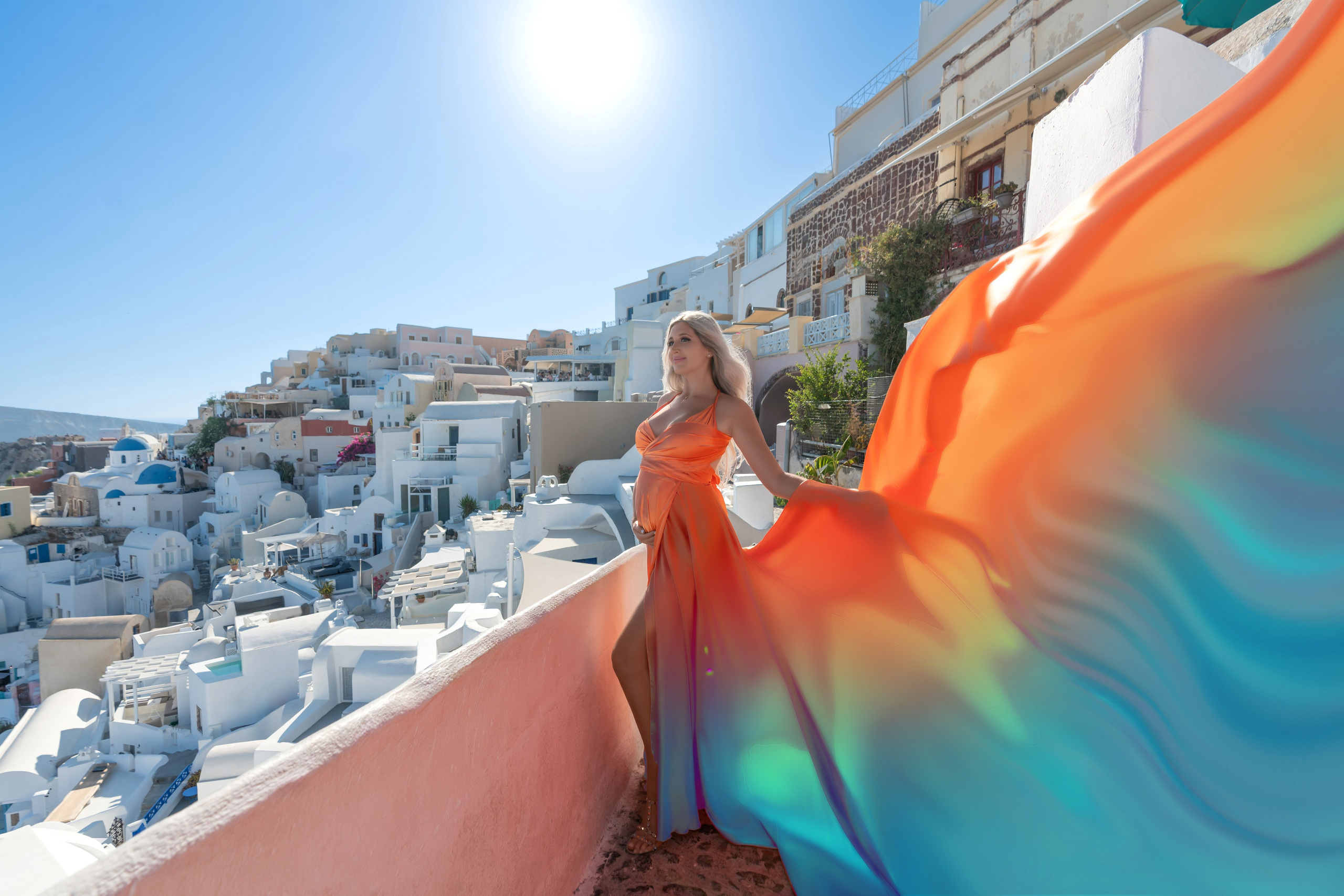 Radiant Motherhood: Pregnancy Photoshoot in Orange Flying Dress in Oia, Santorini by Sokolove"Capture your pregnancy glow with an elegant orange Flying Dress photoshoot in Oia, Santorini. Sokolove’s expert photographers will create stunning images that highlight the beauty of motherhood, set against the breathtaking landscape of Santorini."