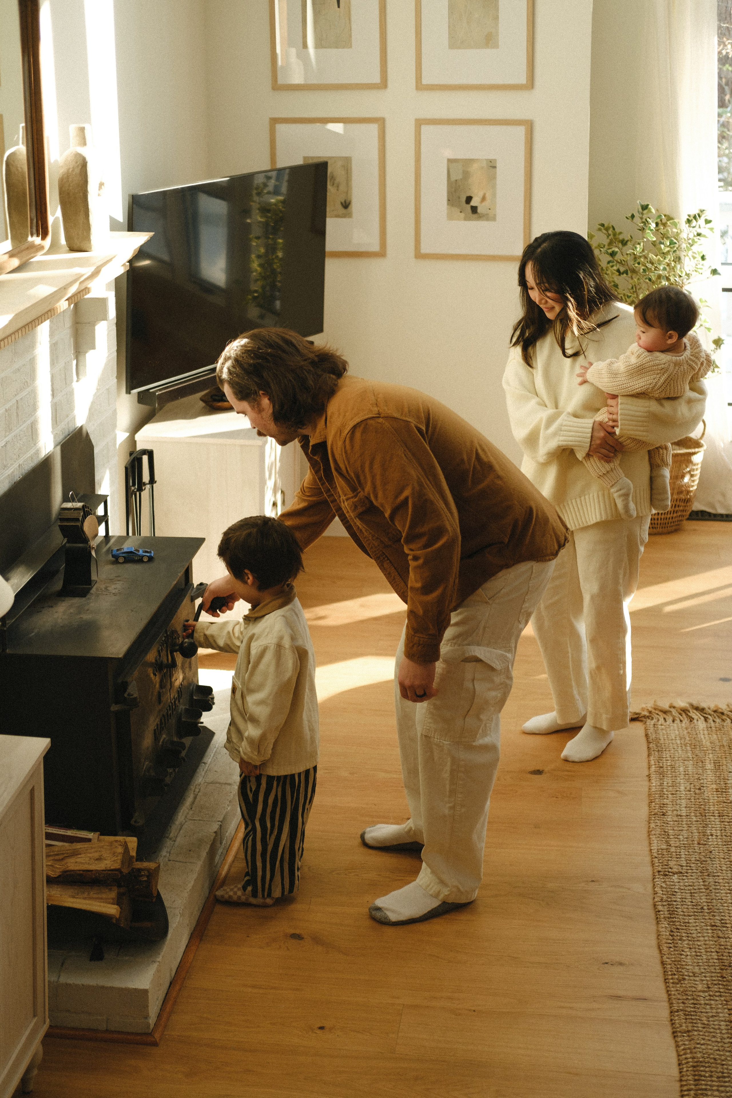 Cozy family cuddles by the wood stove in a snow-covered cottage near Richmond, VA — warmth, light, and winter magic captured beautifully.