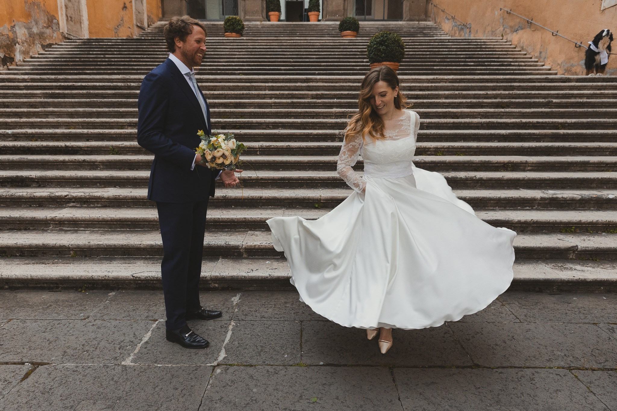 Bride and groom sharing a kiss with the Roman Forum in the background.