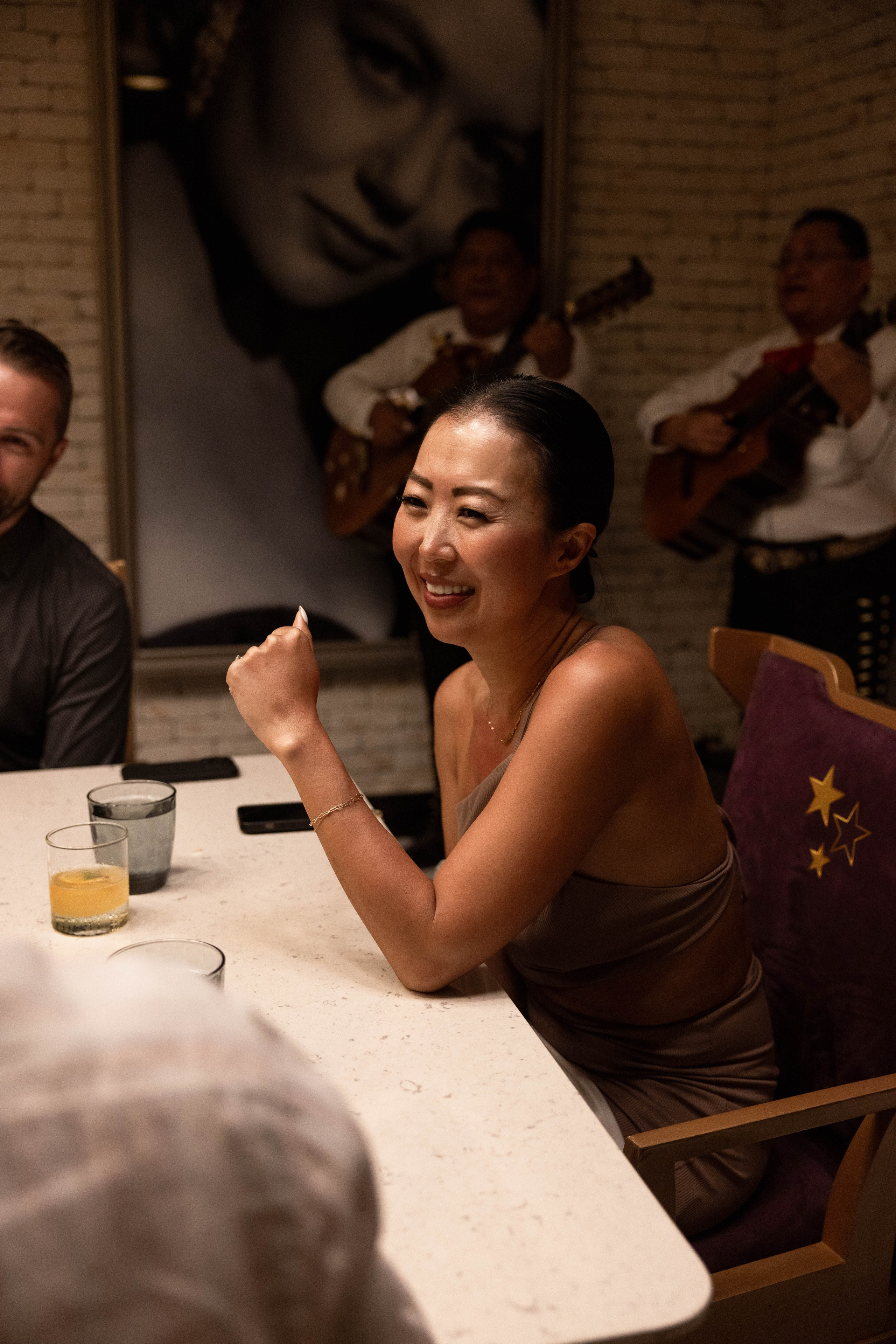 Engaged couple greeting guests at pre-wedding celebration at Planet Hollywood Cancun.