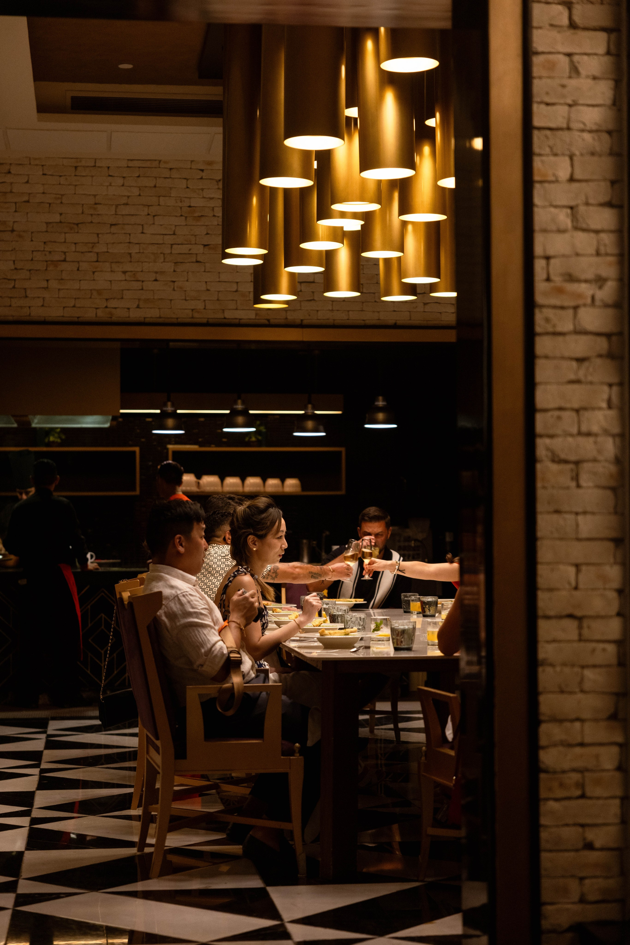Guests sharing quiet conversations during an intimate pre-wedding dinner in Cancun.