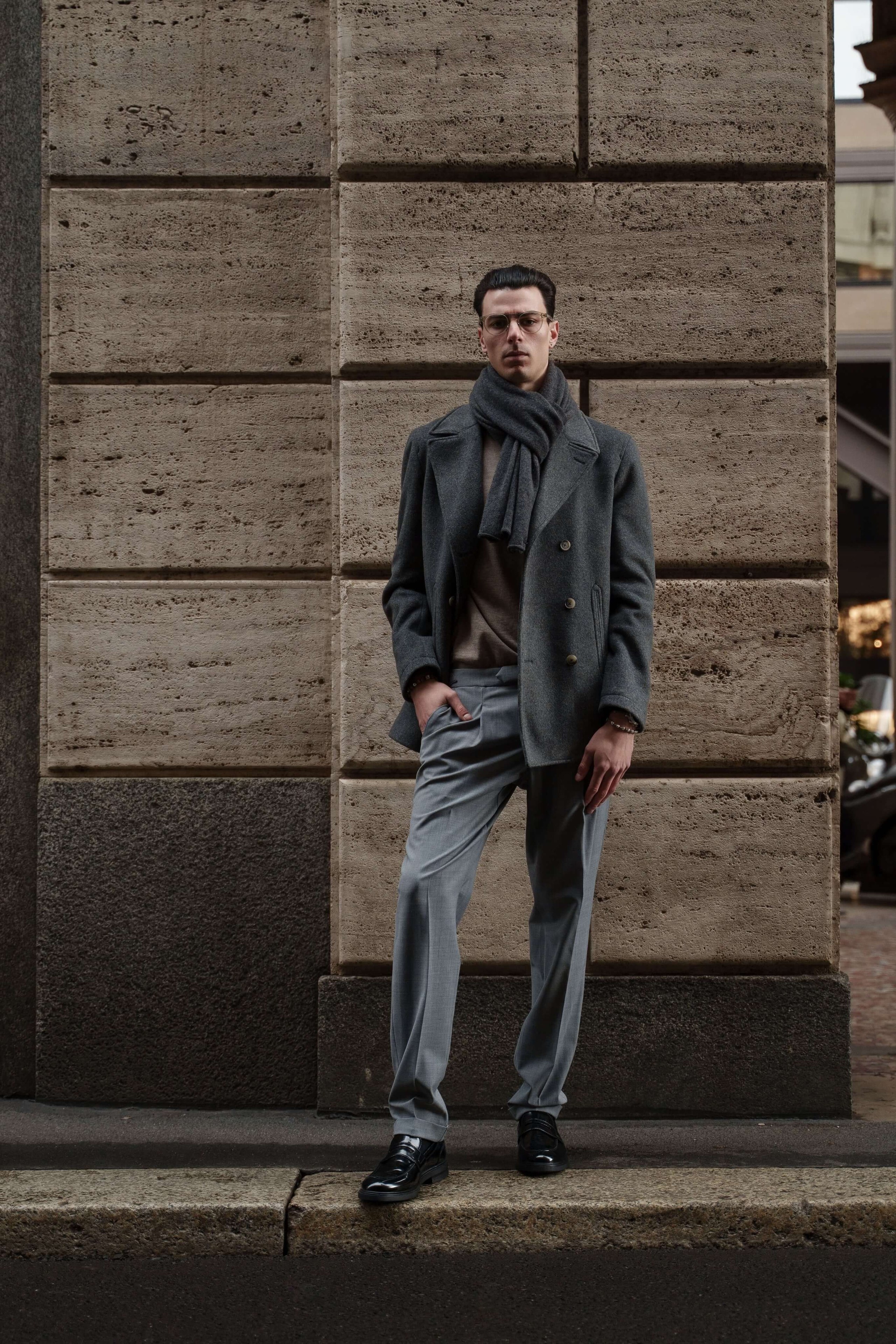 Full-body portrait of male model in formal fashion look, photographed in an urban Milan setting