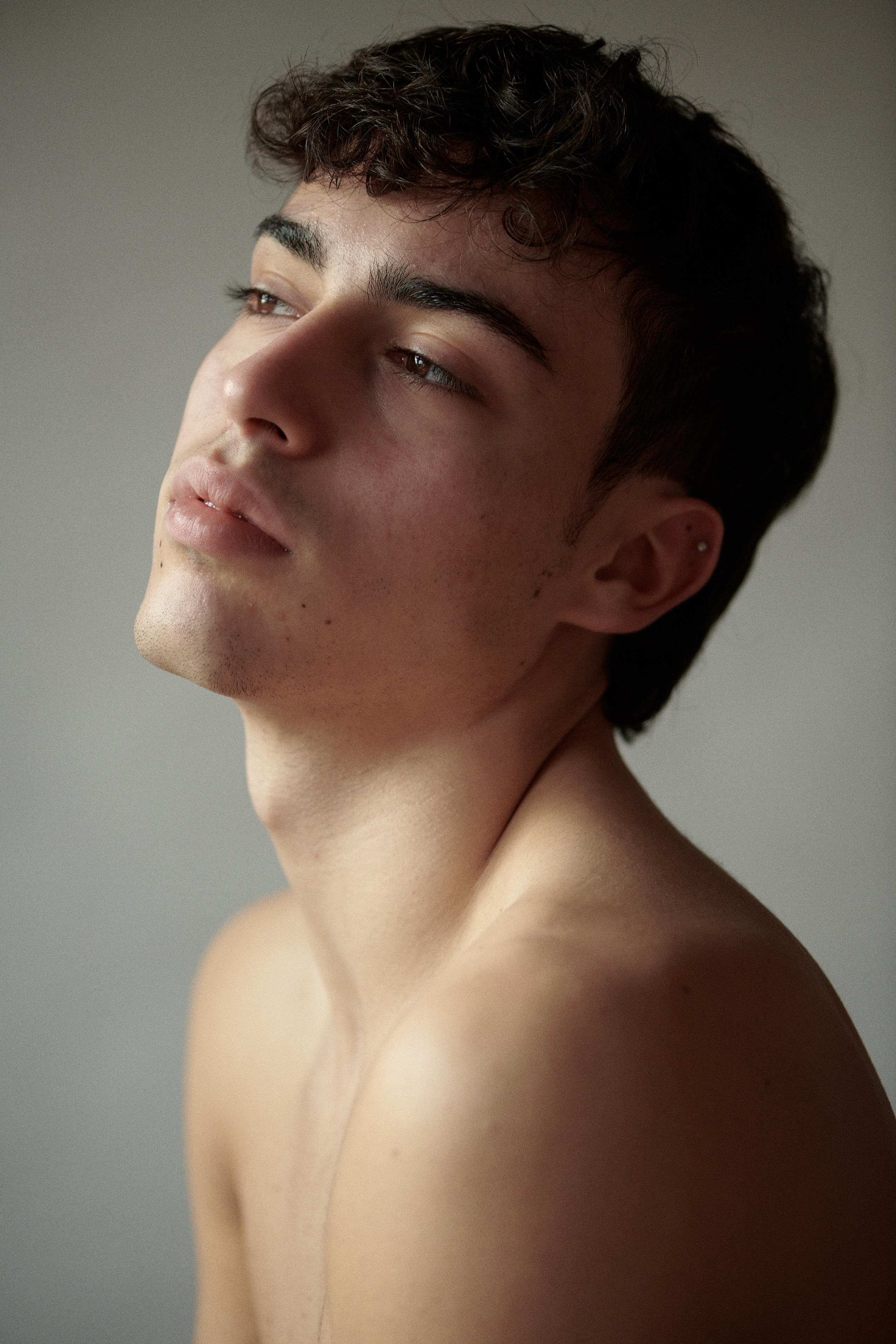 Young man with a pearl necklace.