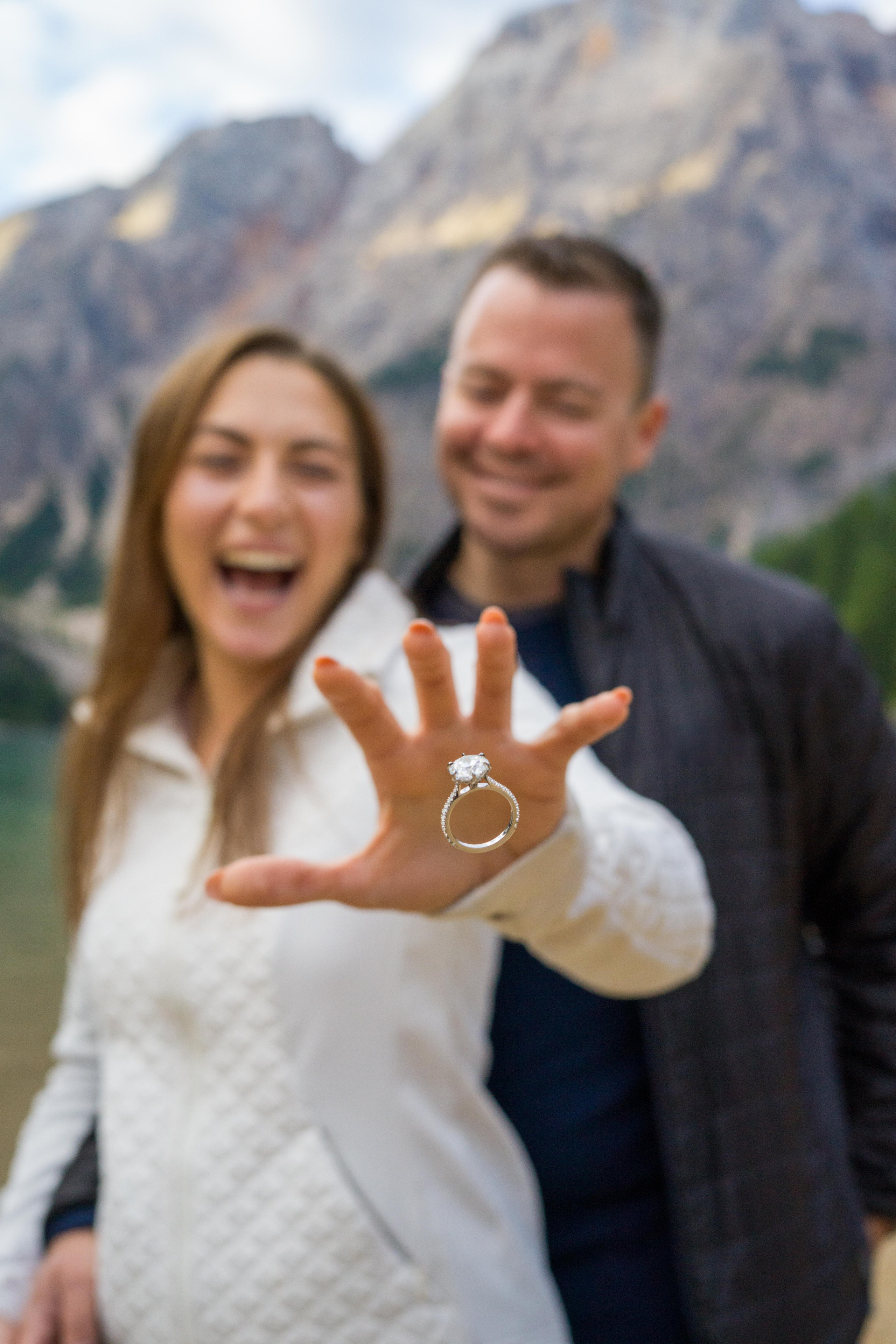 Couple celebrating engagement in mountains.  Lake Braies