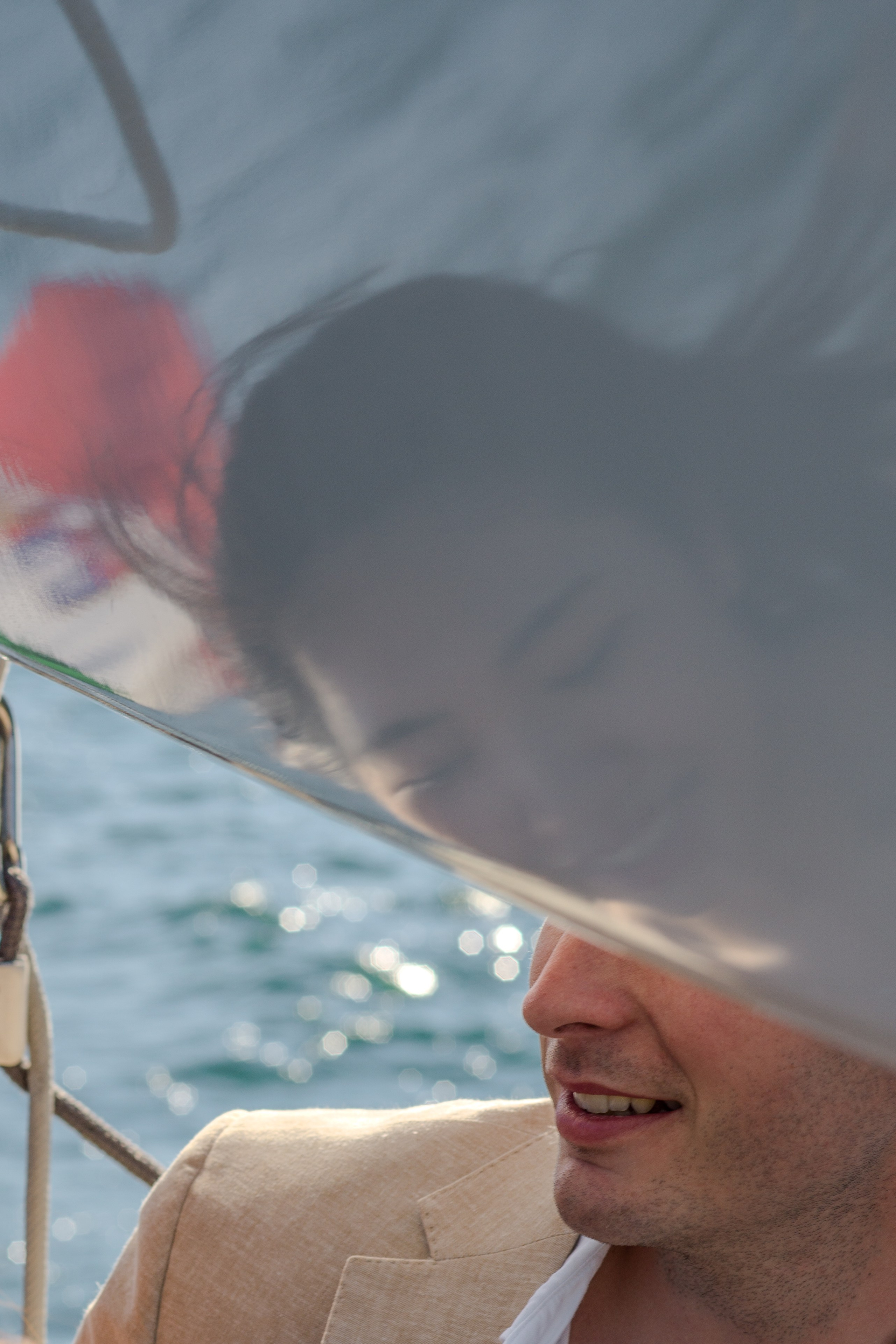 Elegant engagement scene in Villa Melzi with reflections of the lake in the background.