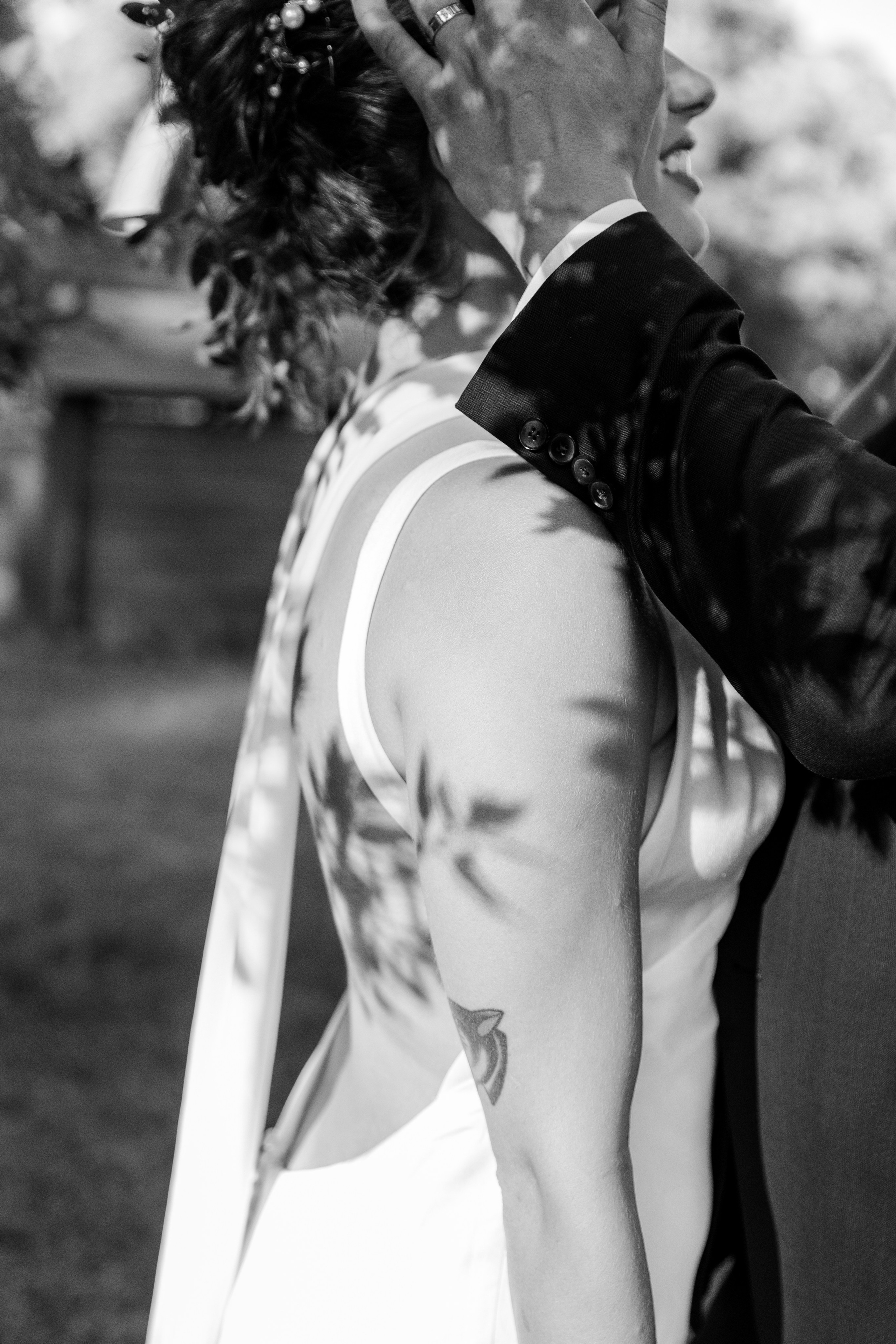 A couple having a close moment with each other under the tree. 