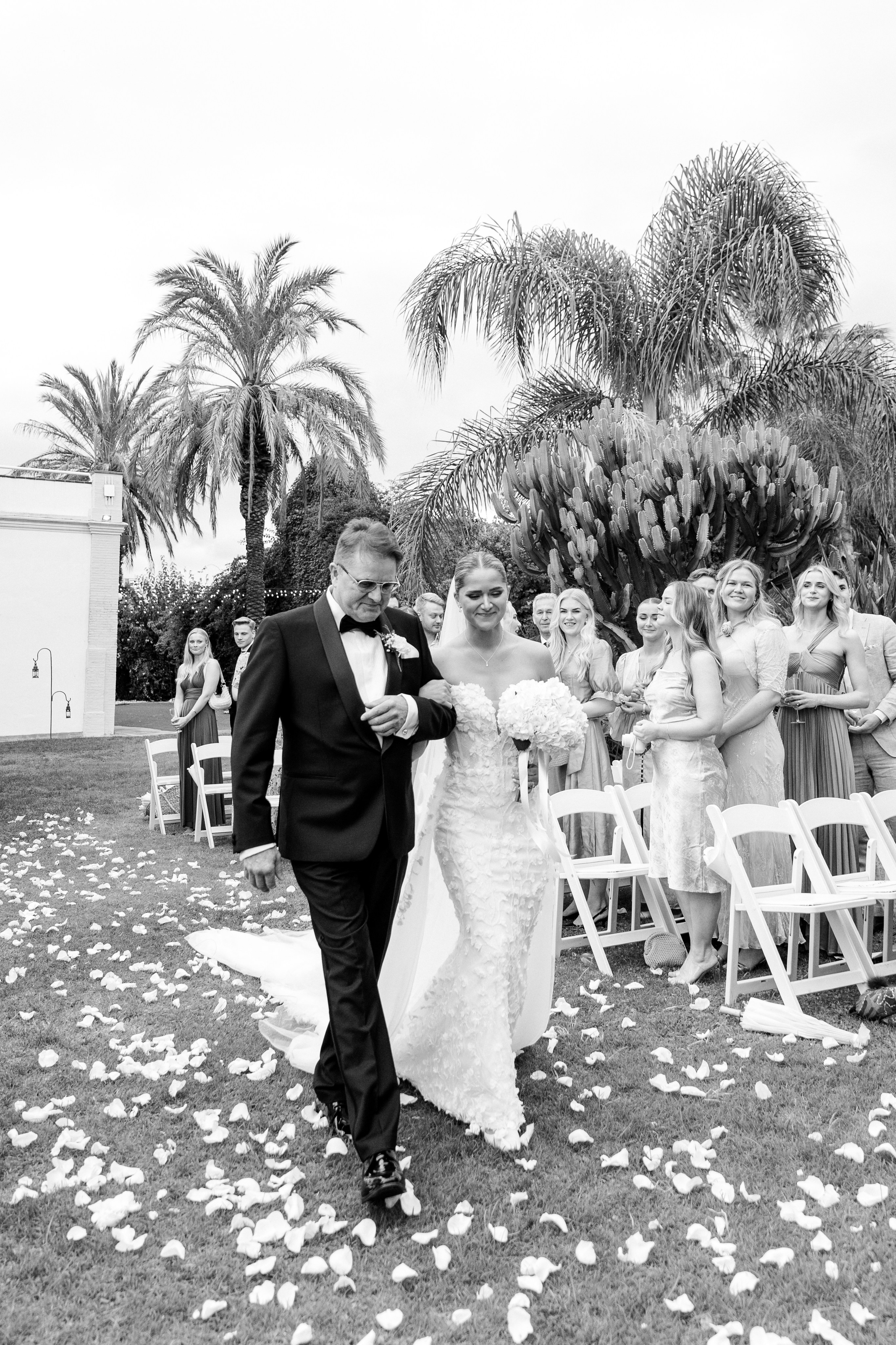 Emotional moment: father walking his daughter down the aisle to mwwt the groom at a Spanish wedding venue.