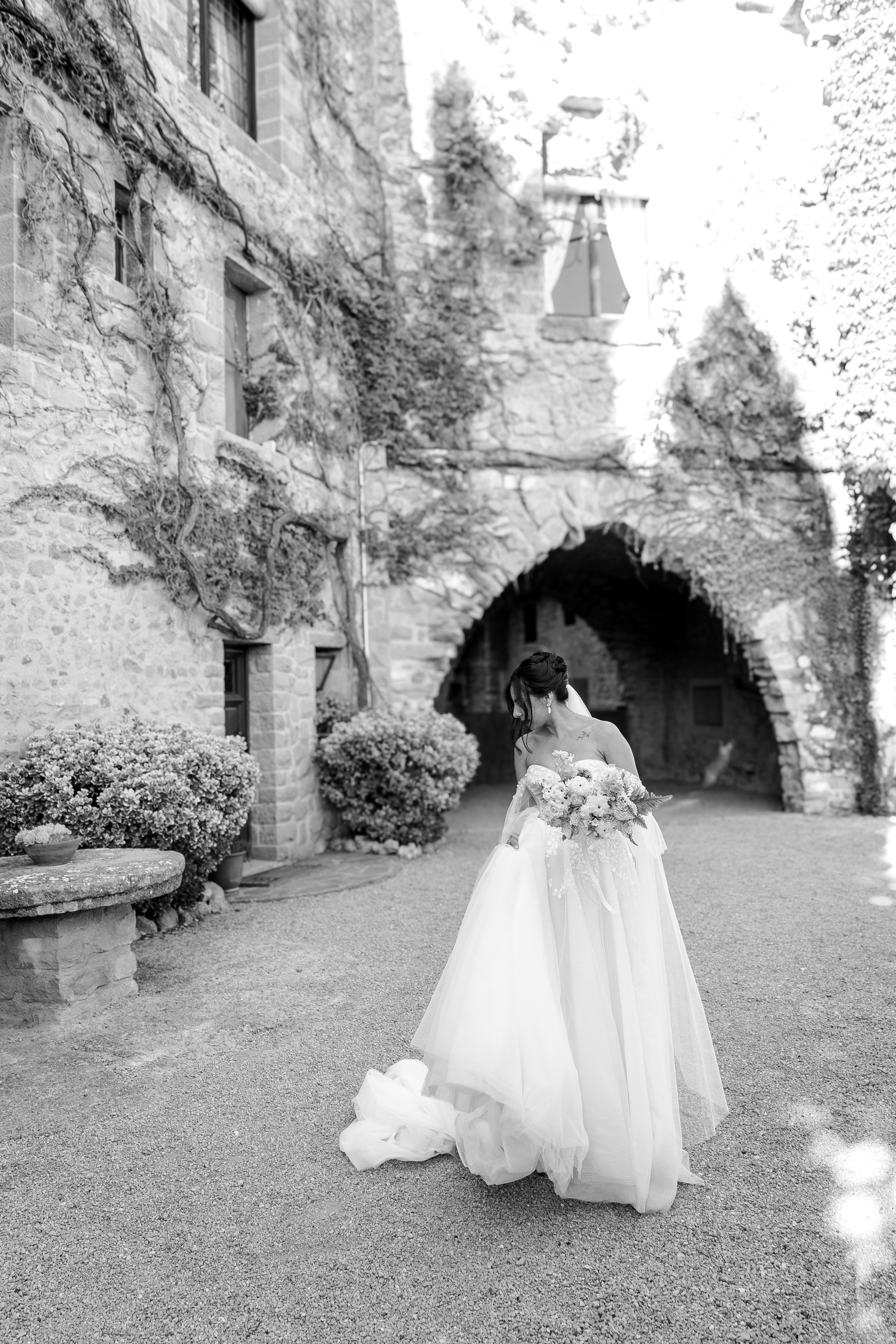 Editorial shots of a bride walking in front of the destination wedding venue in Spain 