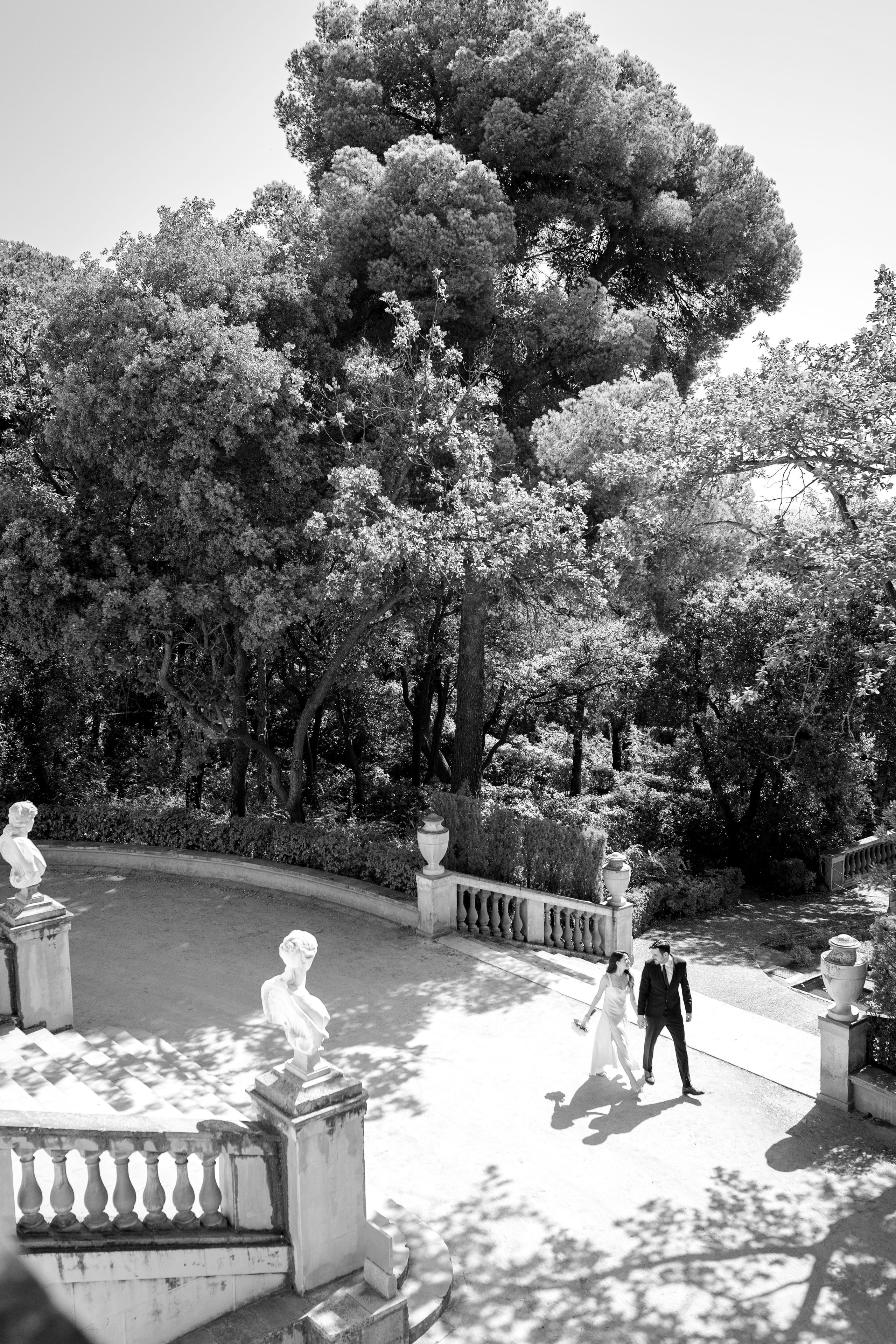 Romantic couple walking hand-in-hand in the park in Barcelona. 