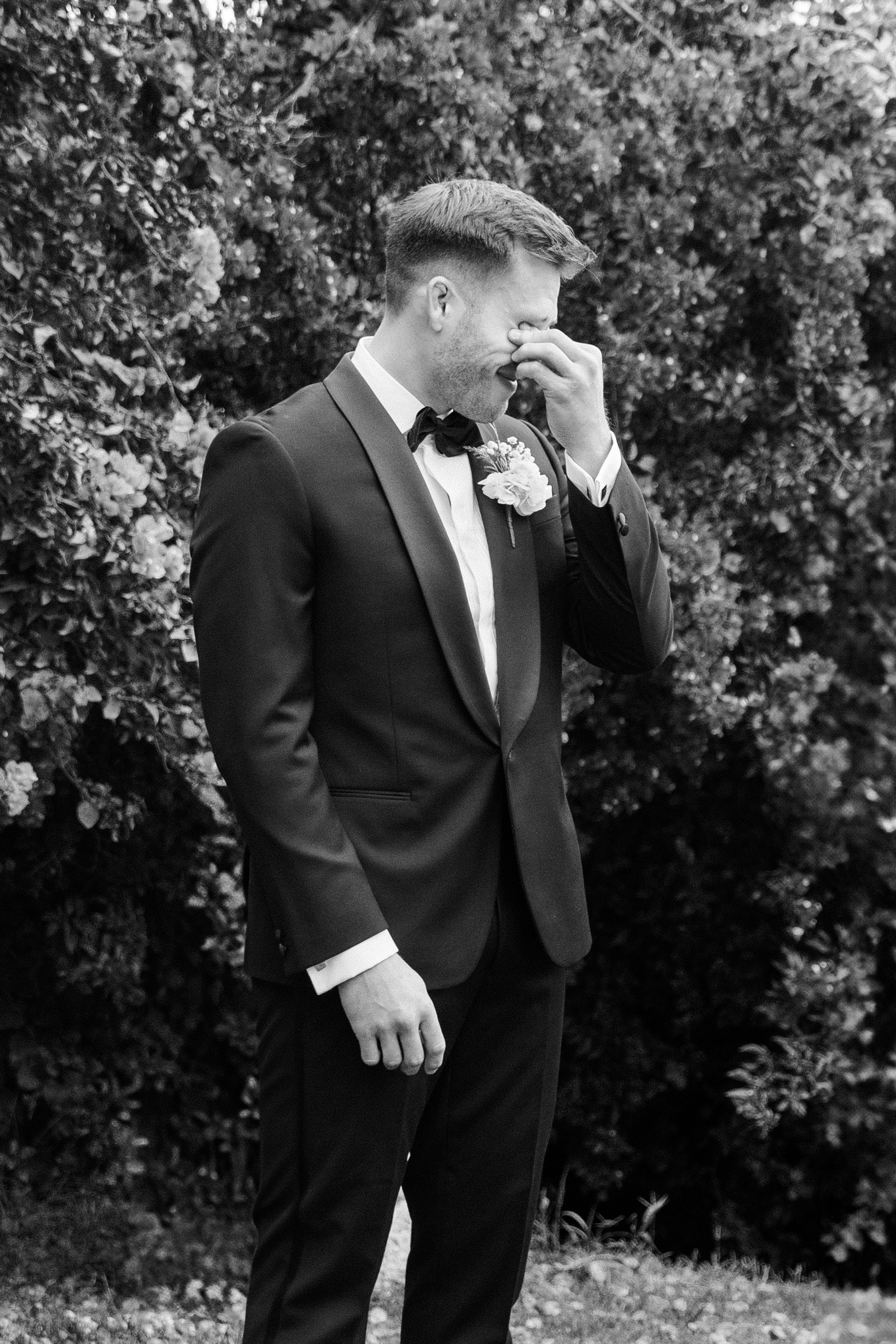 Emotional groom expressing strong emotions while waiting for the bride. 