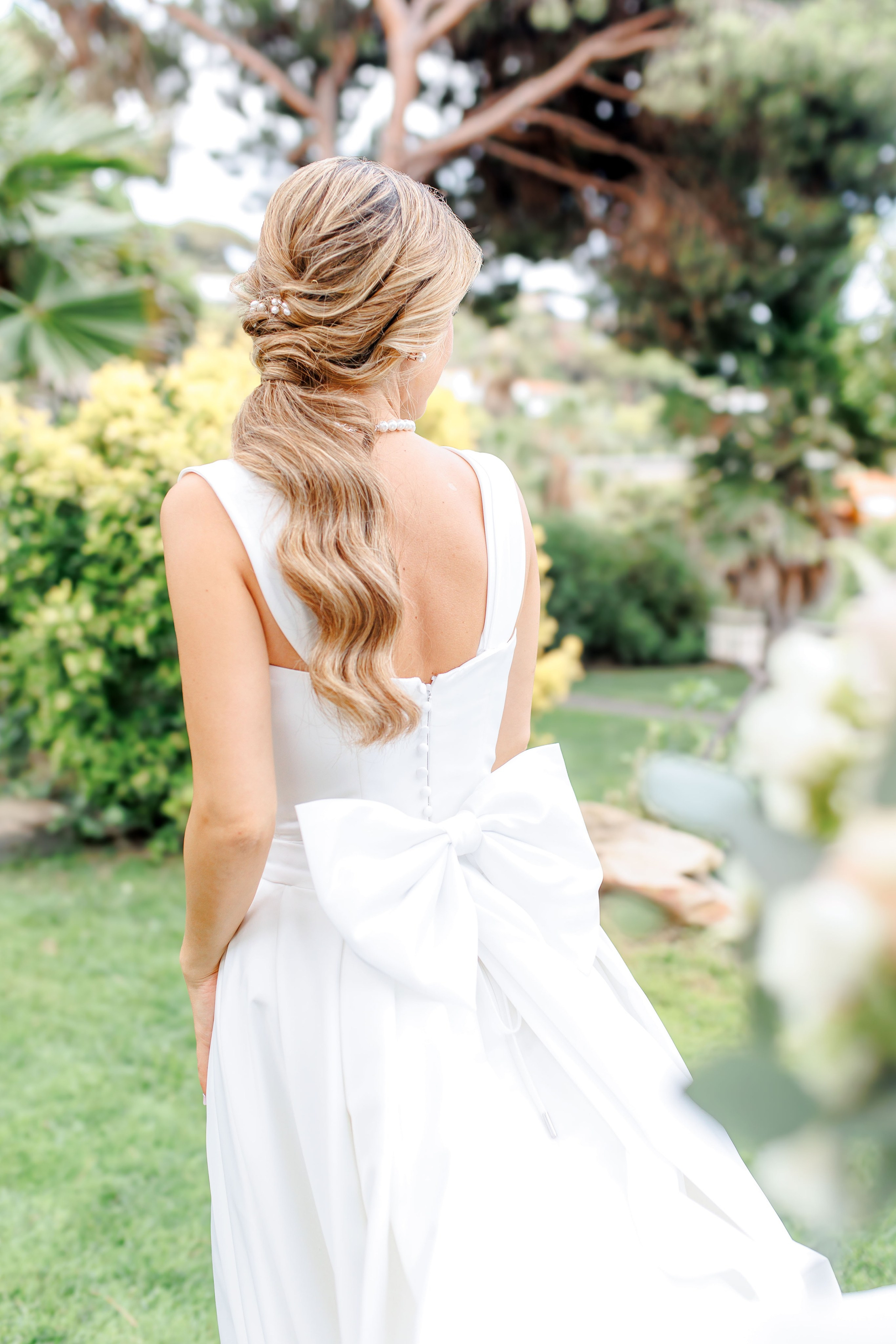 Detailed shoot of a bride from the back showing the beauty of the wedding dress.