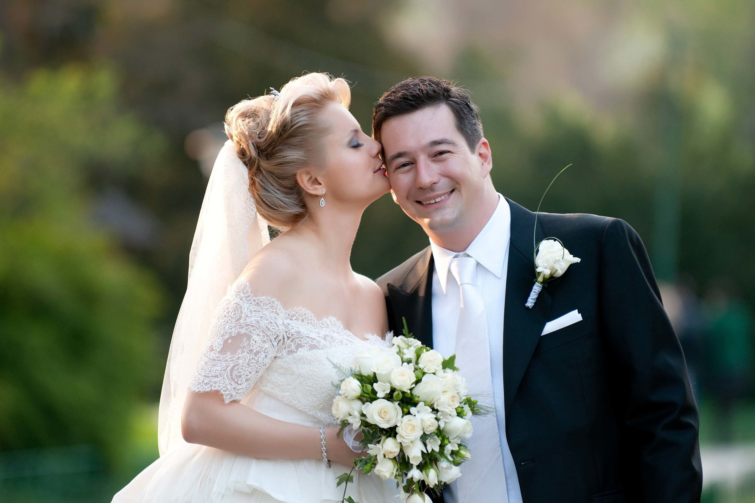 Wedding photography session Museum Botanical Garden of Bucharest Romania. Wedding photographer Nikon D850 Bride kissing groom's forehead