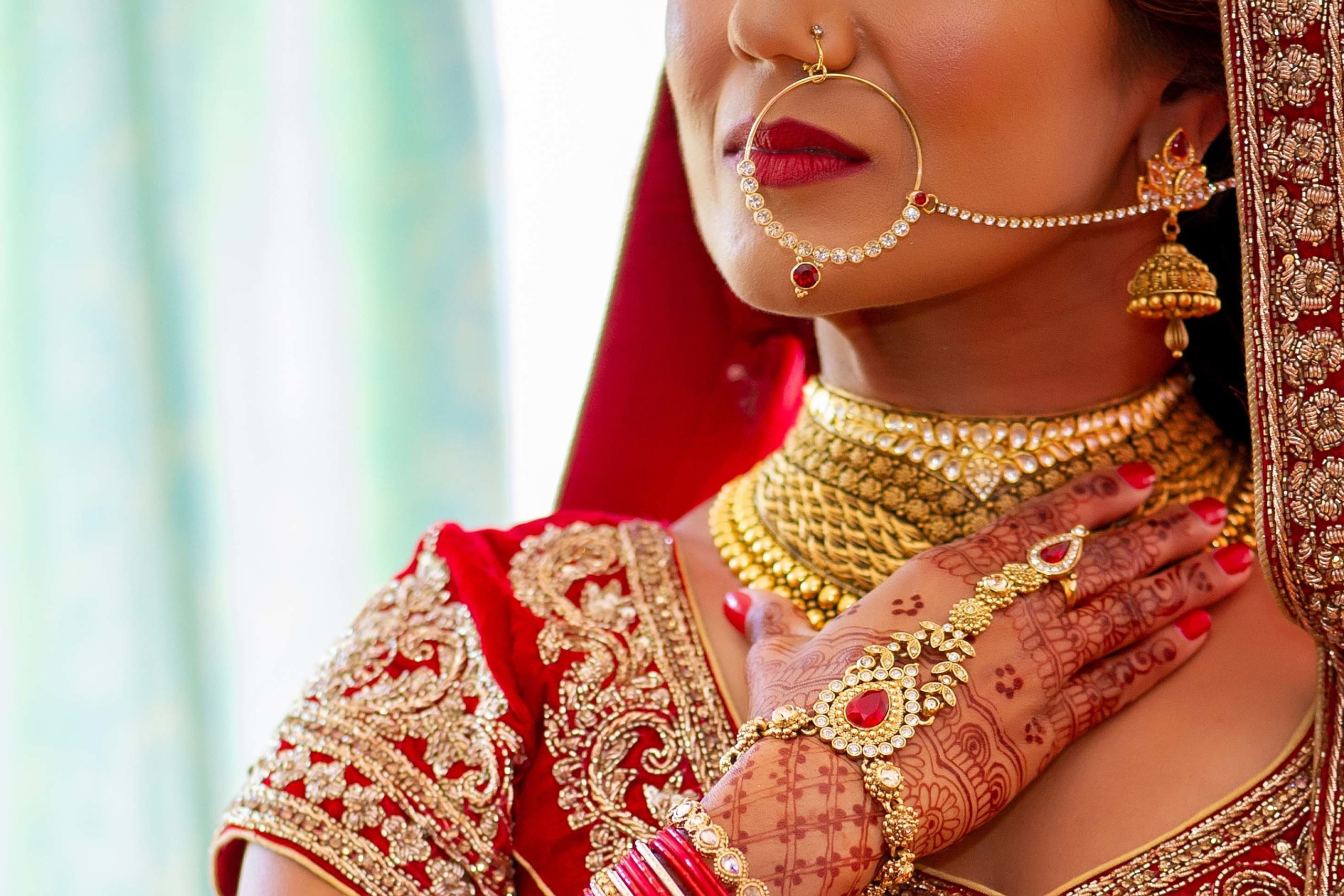Wedding photographer Private Residence, Guildford UK  Asian bride putting a necklace Nikon D850