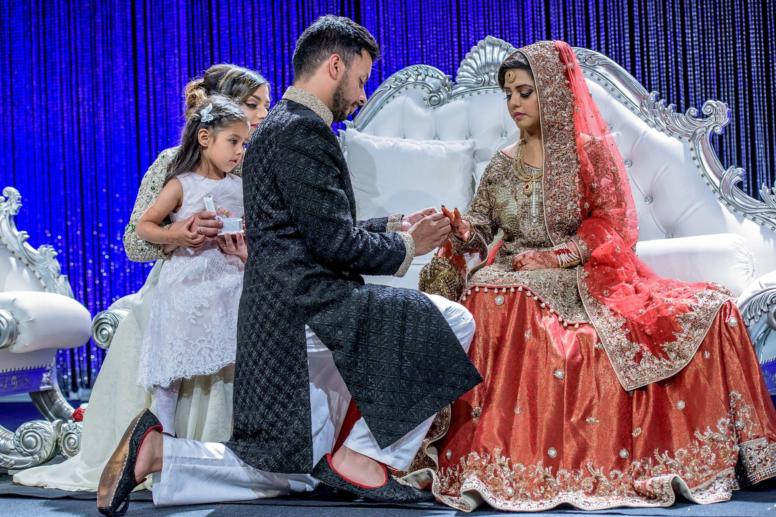 Pakistani Wedding photographer Scandic Holmenkollen Park Oslo Norway Nikon D850 groom putting the ring on bride's finger