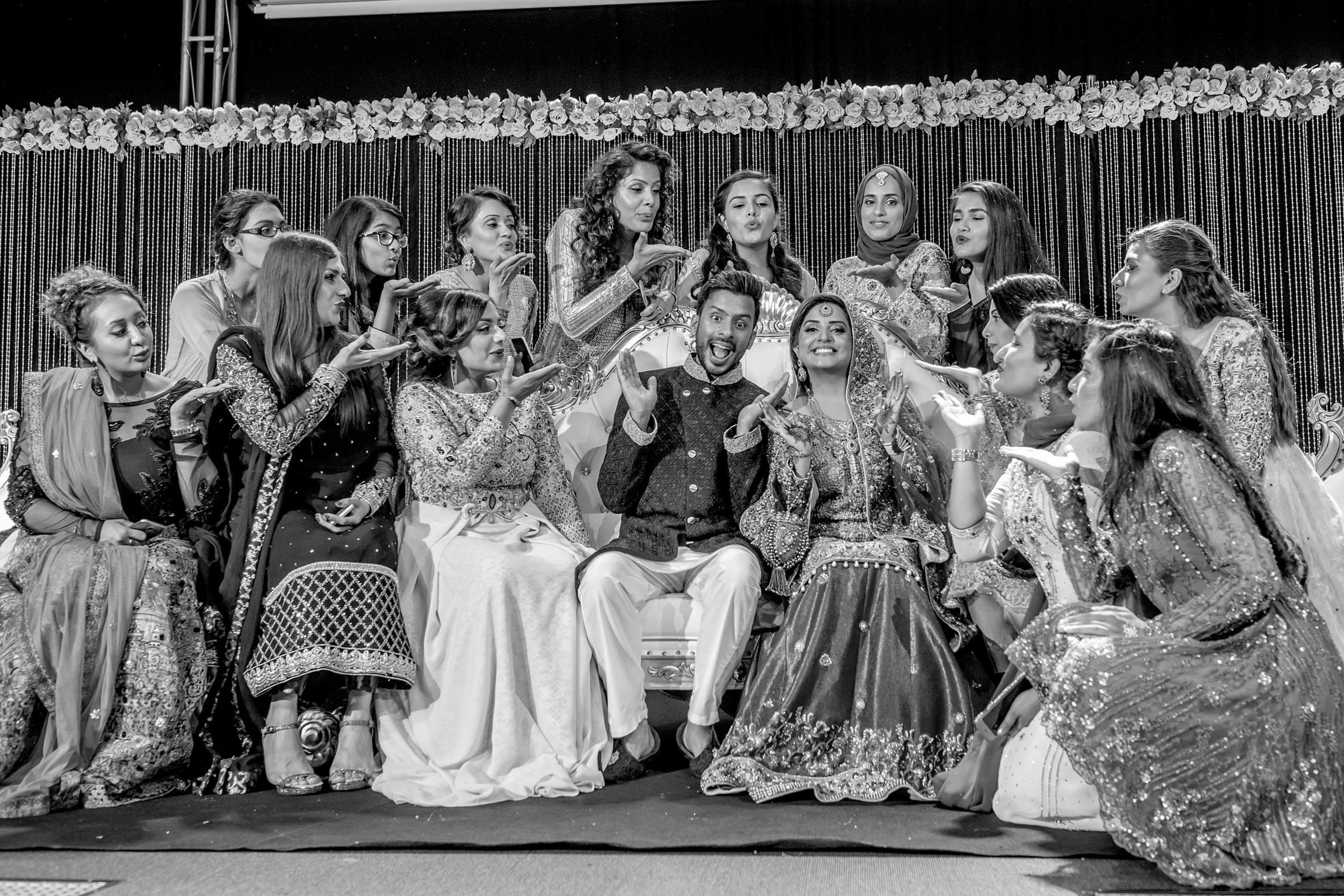Pakistani Wedding photographer Scandic Holmenkollen Park Oslo Norway Nikon D850 Groom with his bride surrounded by bridesmaids and female guests