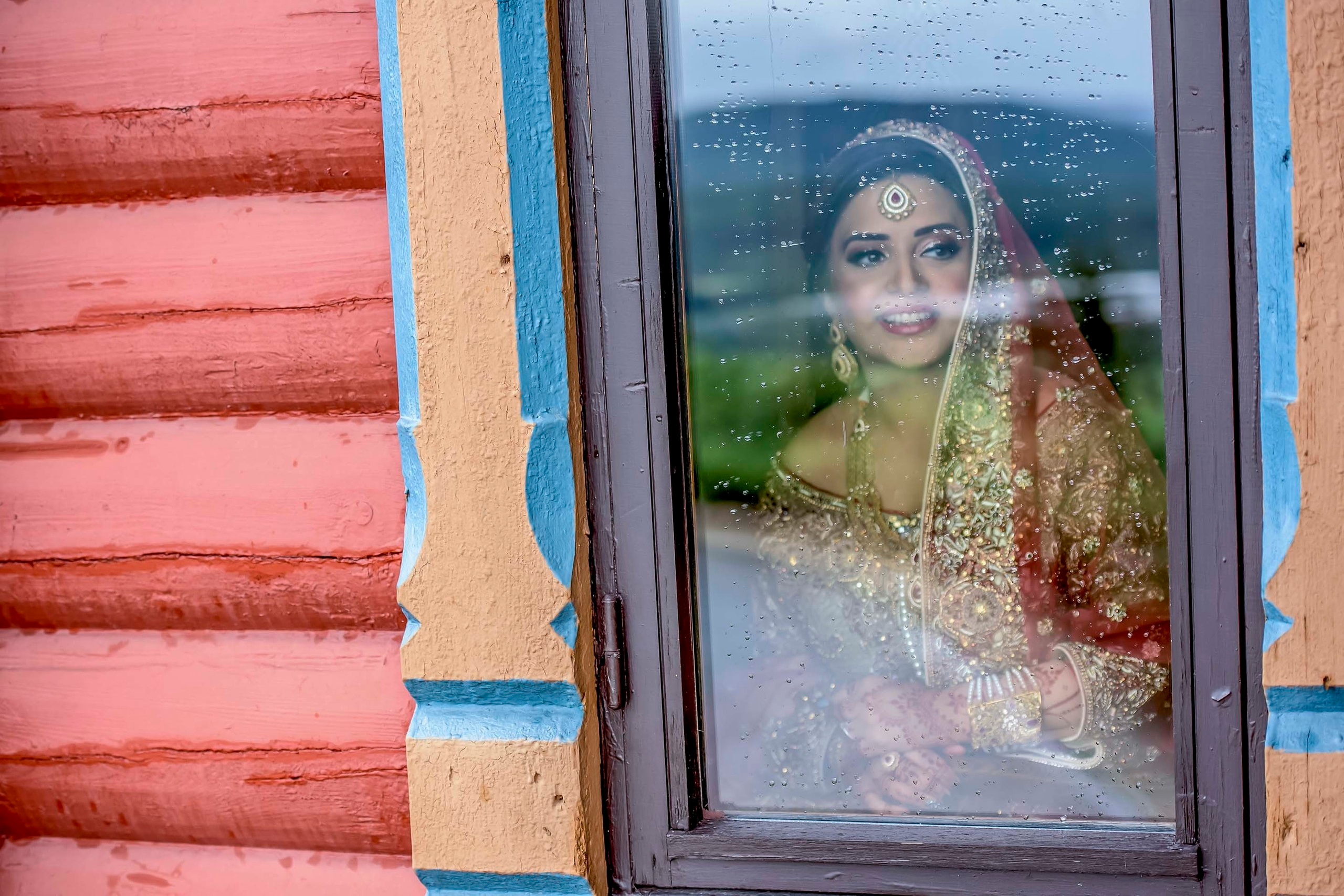 Wedding photographer Scandic Holmenkollen Park Oslo Norway Nikon D850 Bride watching outsie window at the rain
