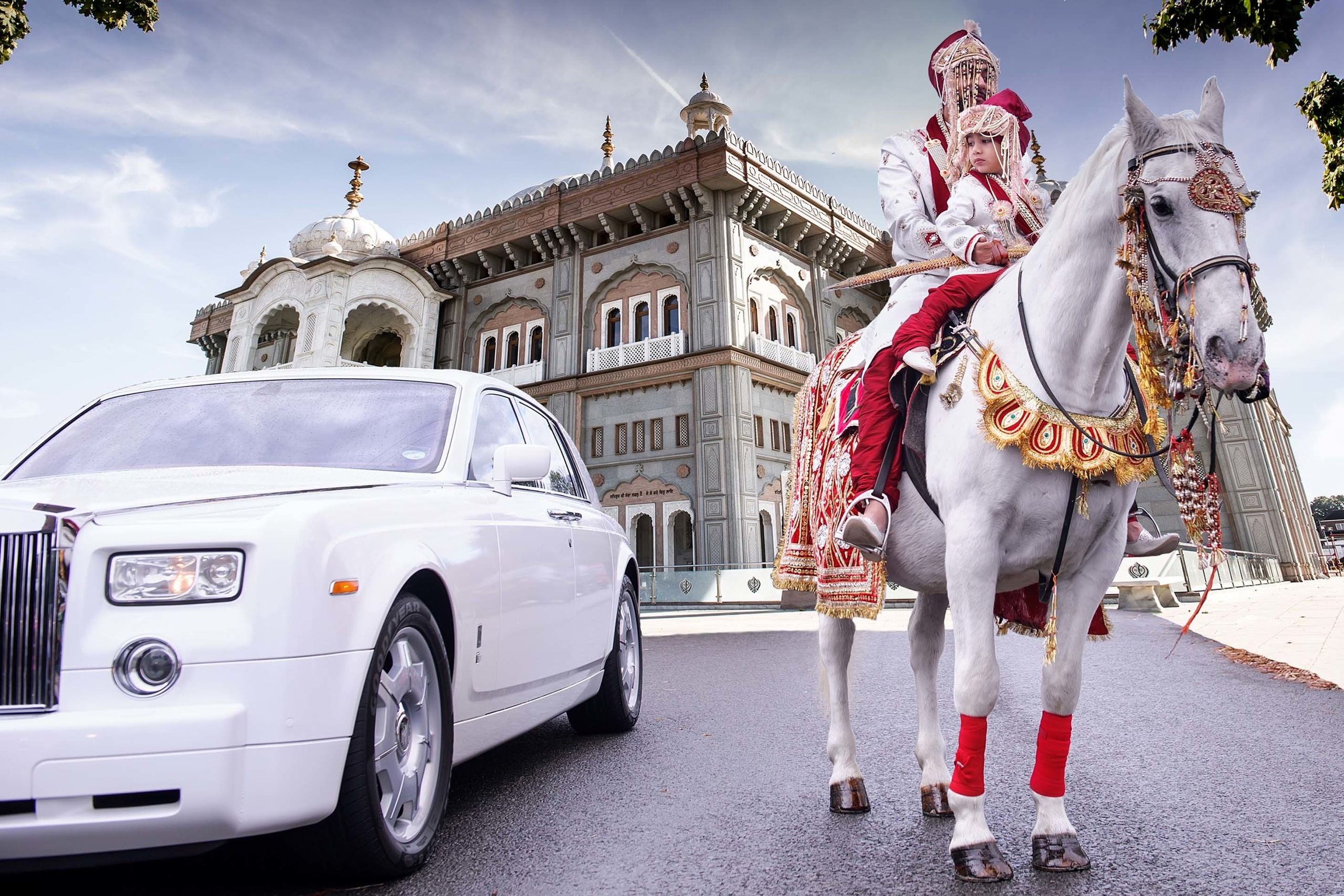 Sikh groom on horse near a Rolls Royce car Sikh Temple Gurdwara Southall London UK. Wedding photographer Nikon D850