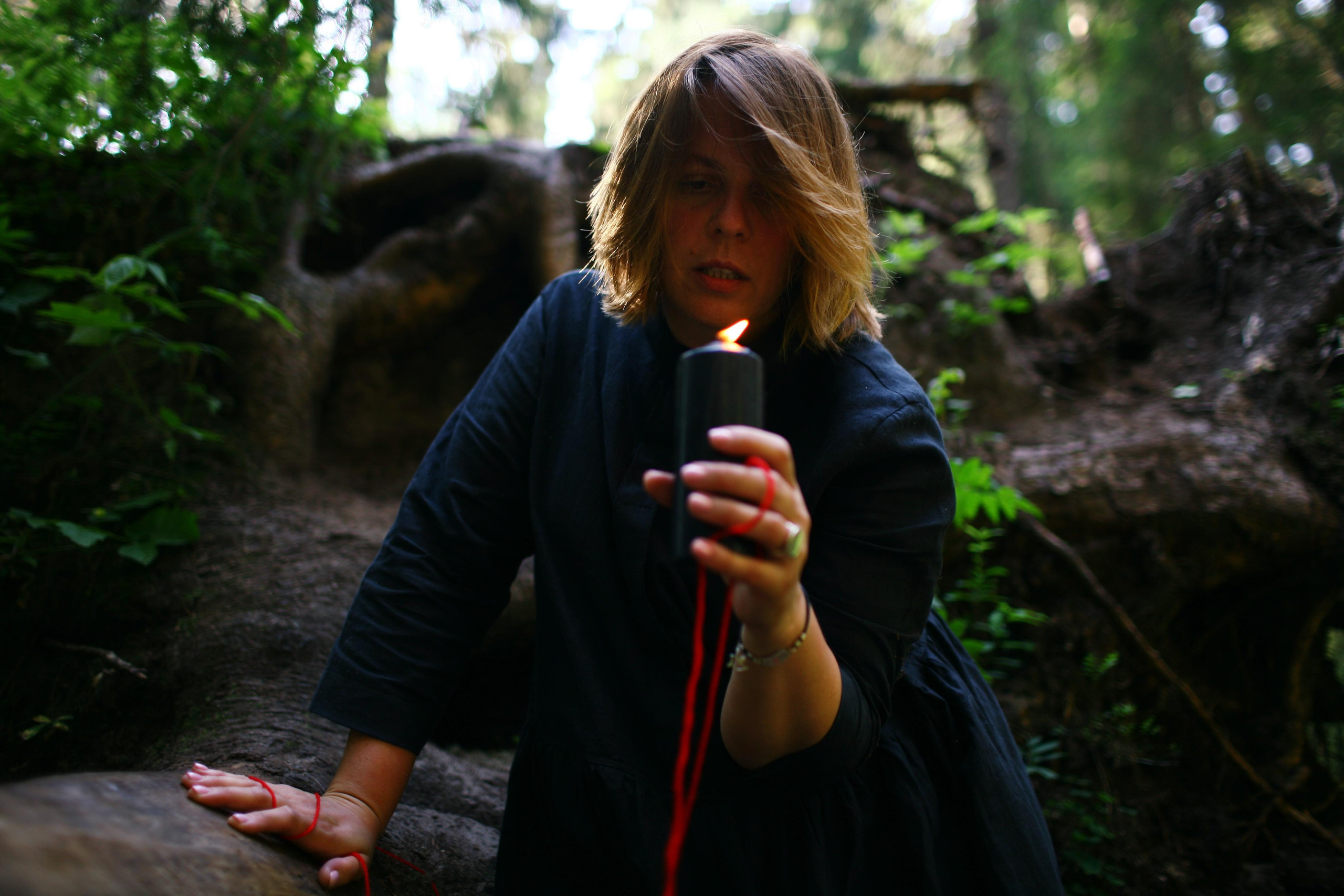 Anna, by herself. Woods and a little bit fire