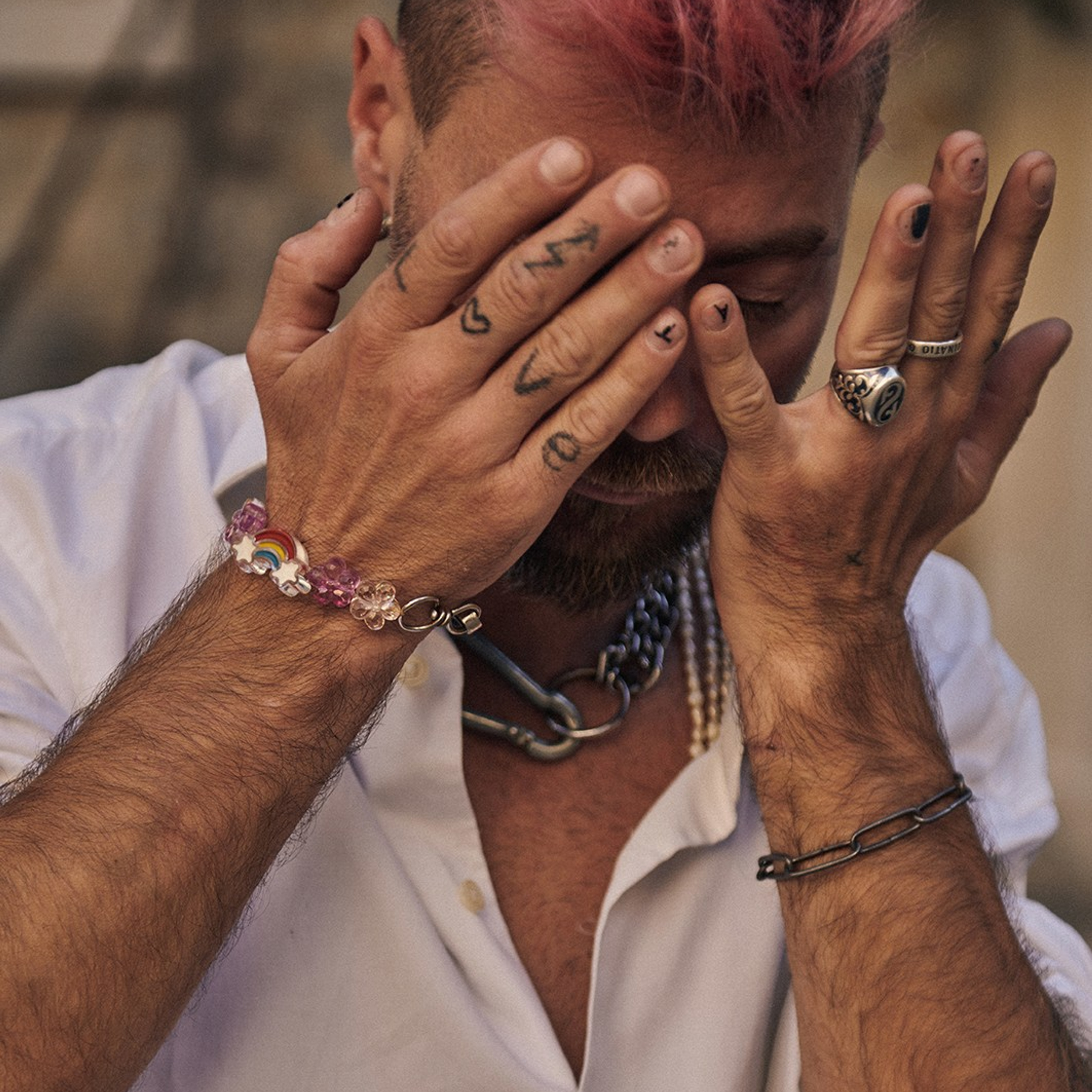 Portrait of a man showcasing stylish jewelry in a soft natural light 