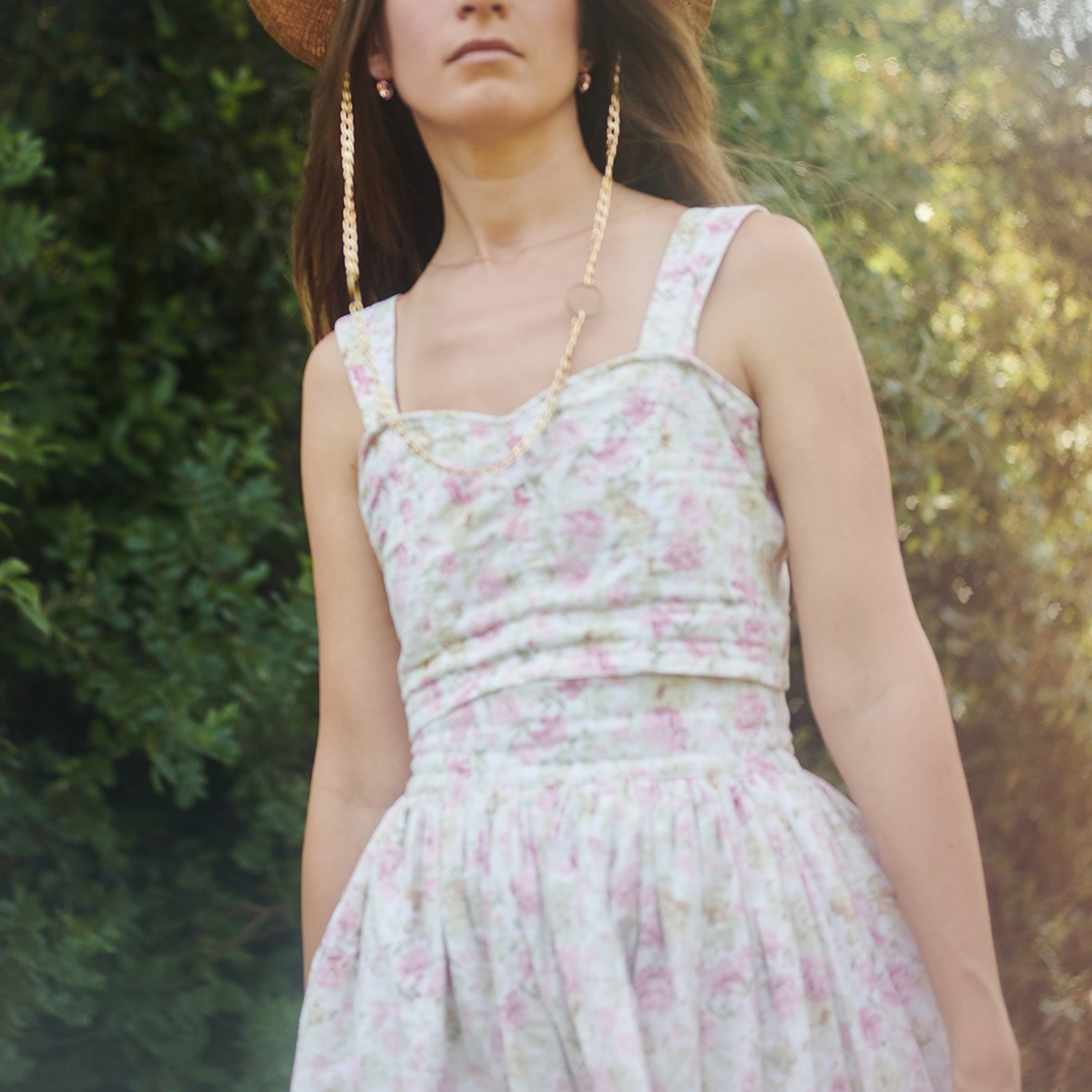 Fashion portrait of a woman in a hat, photographed in a forest
