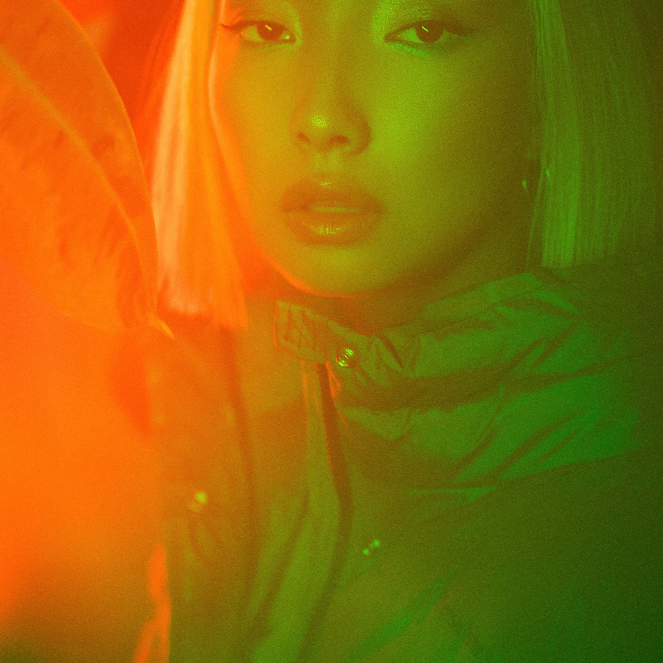 A portrait bathed in a surreal green light, capturing a person with a serene expression, their features highlighted by the contrasting warm and cool tones, creating an otherworldly ambiance