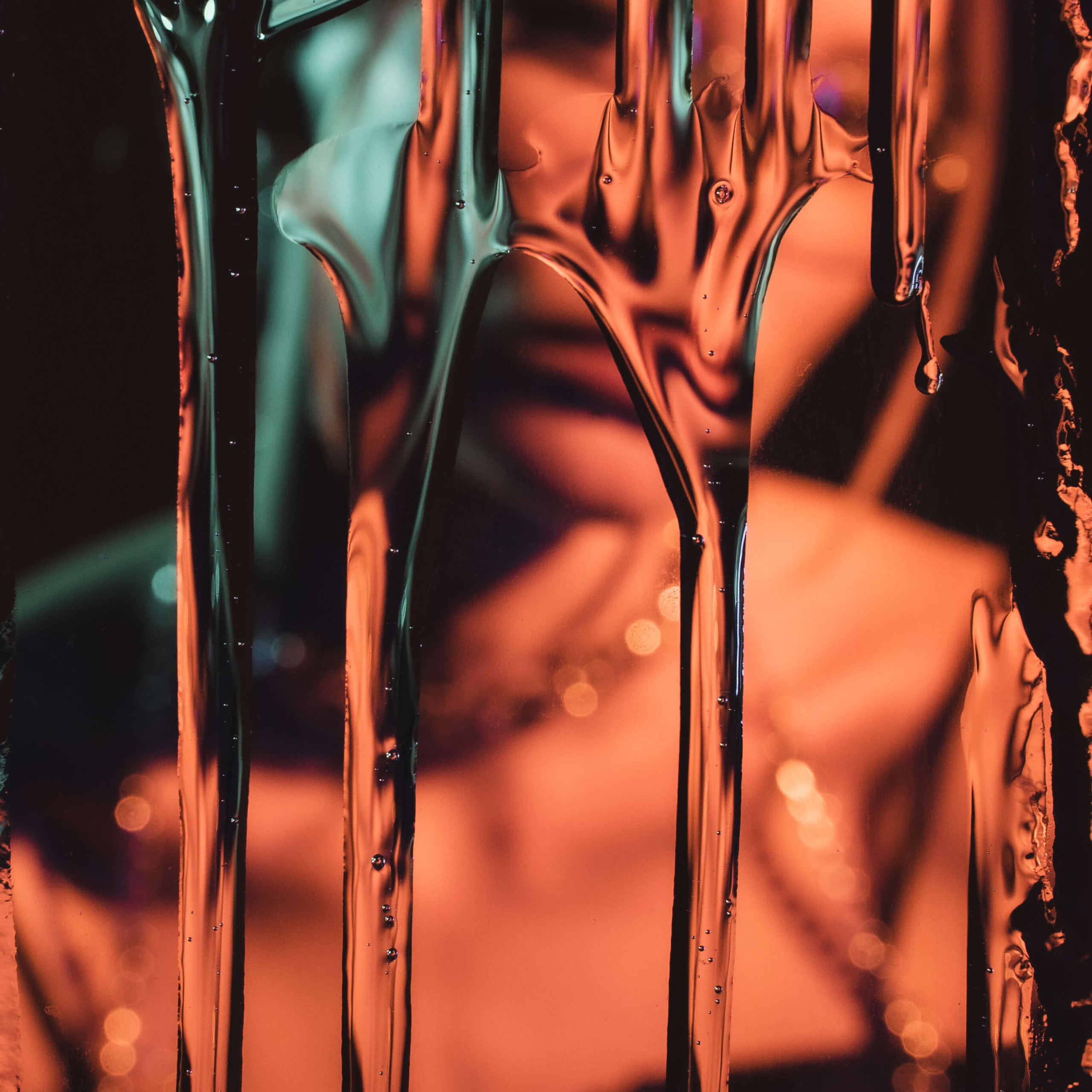 Photographer's abstract vision of light refracting through water droplets, creating a canvas of amber tones and fluid shapes that captivate the eye