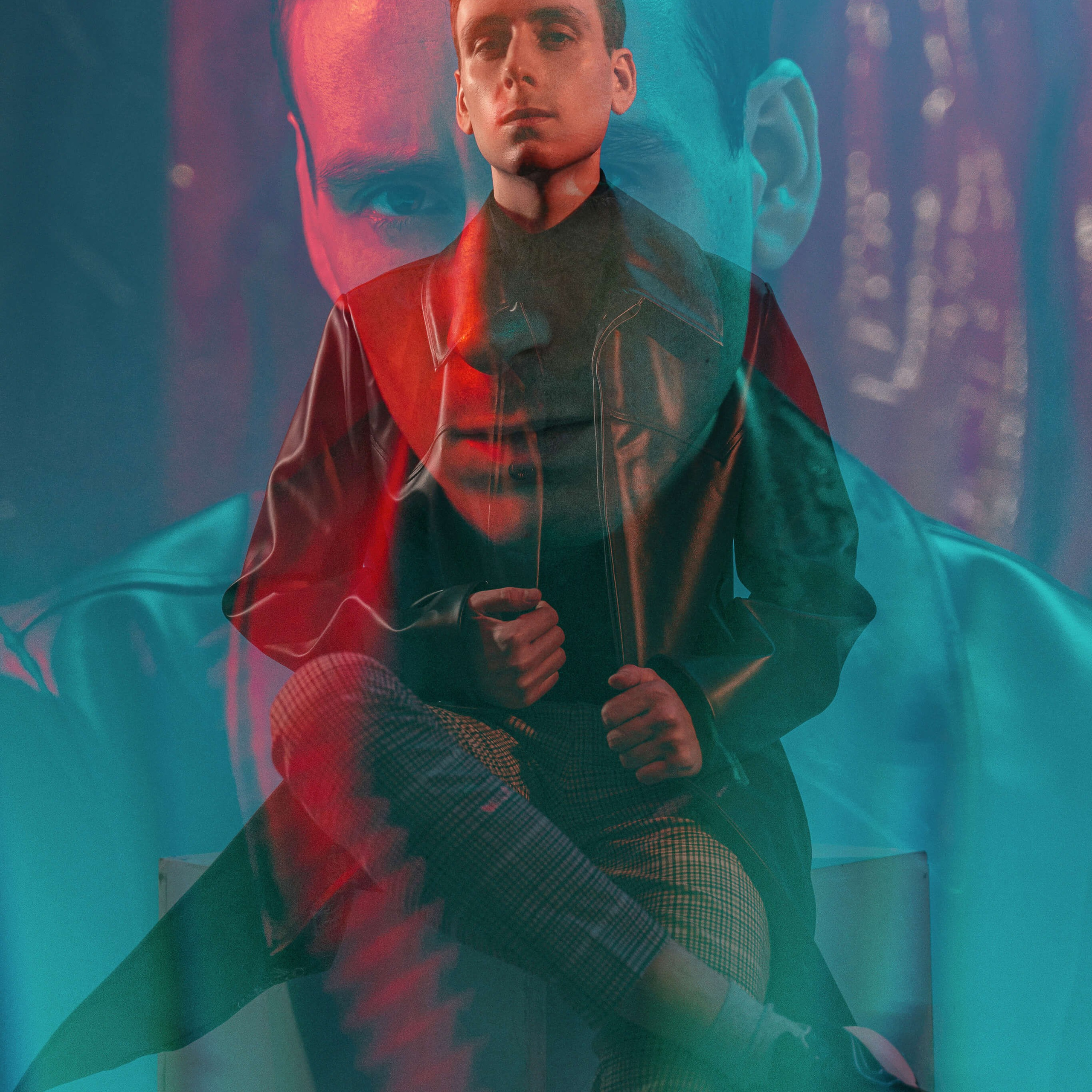 Сreative double exposure portrait capturing a man in a layered visual narrative, with red and blue hues casting a surreal and artistic light on his introspective pose