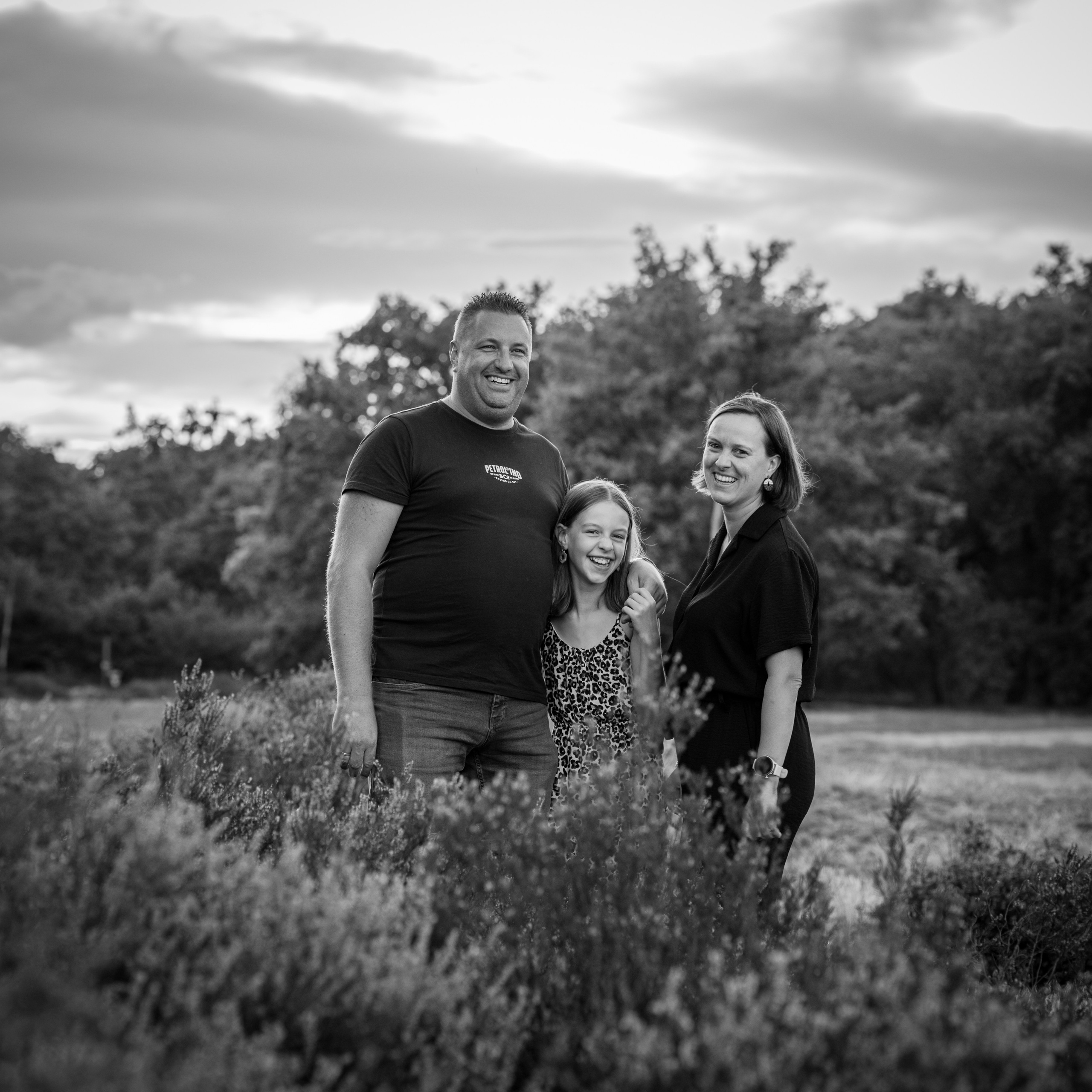 Zwart-wit familieportret buiten in natuurlijk licht tijdens spontane gezinsfotoshoot - Kapture Fotografie