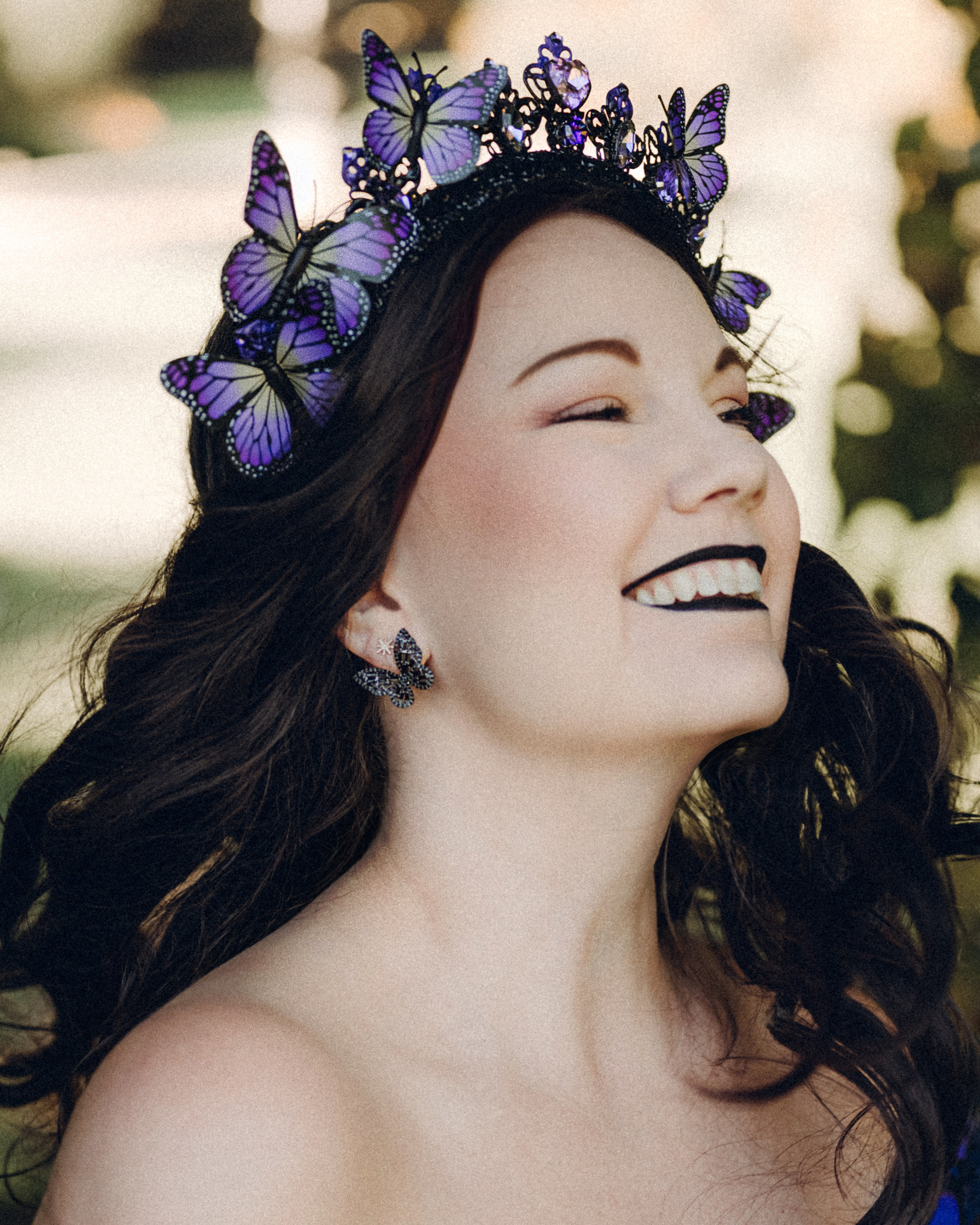 Butterfly purple fairy in a blooming garden