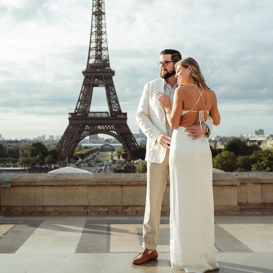 Elegant couple at the sunrise hugging with an Eiffel Tower view