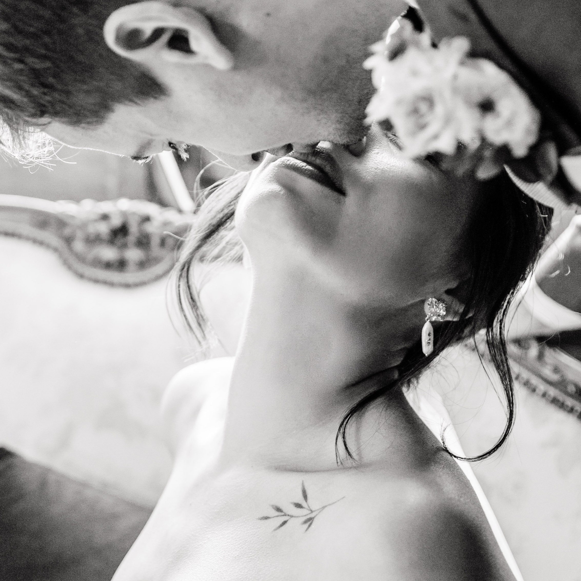 Bride and groom share an intimate kiss before meeting with the guests