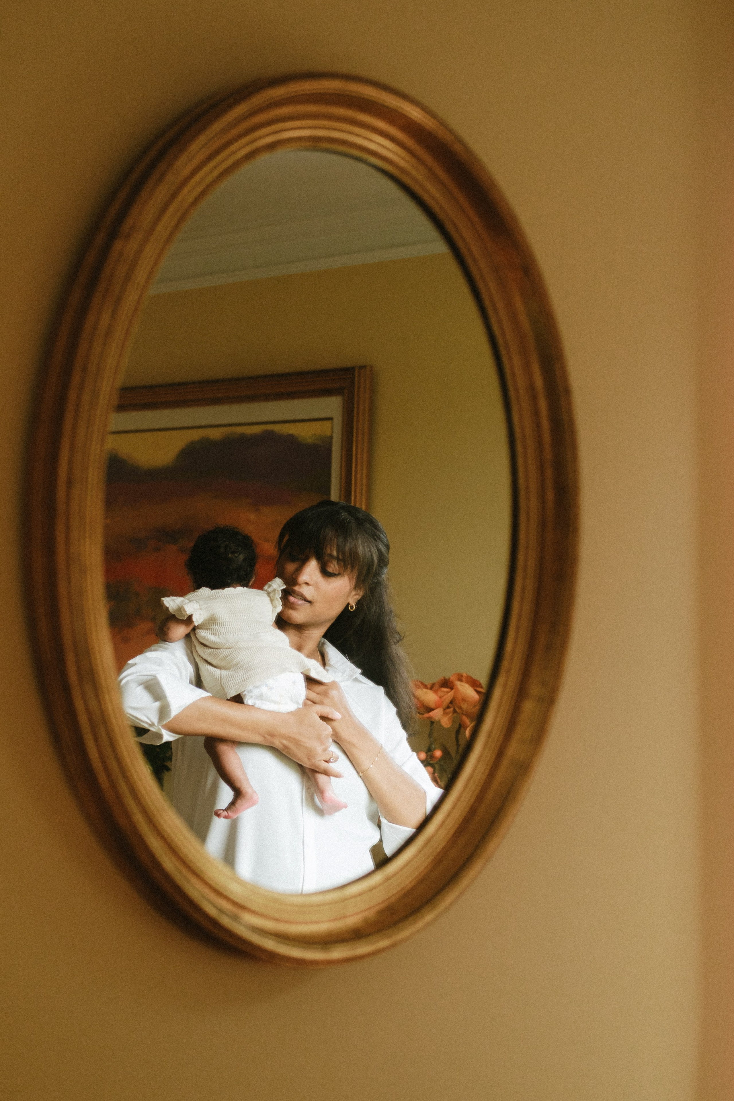 Stunning portrait of a mom holding her baby son in her arms close to her face