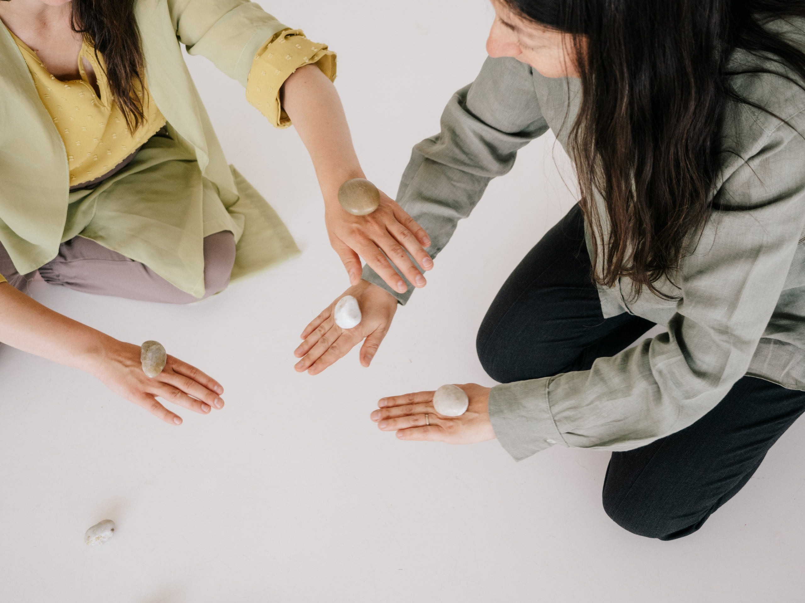 Hands placing little stones.