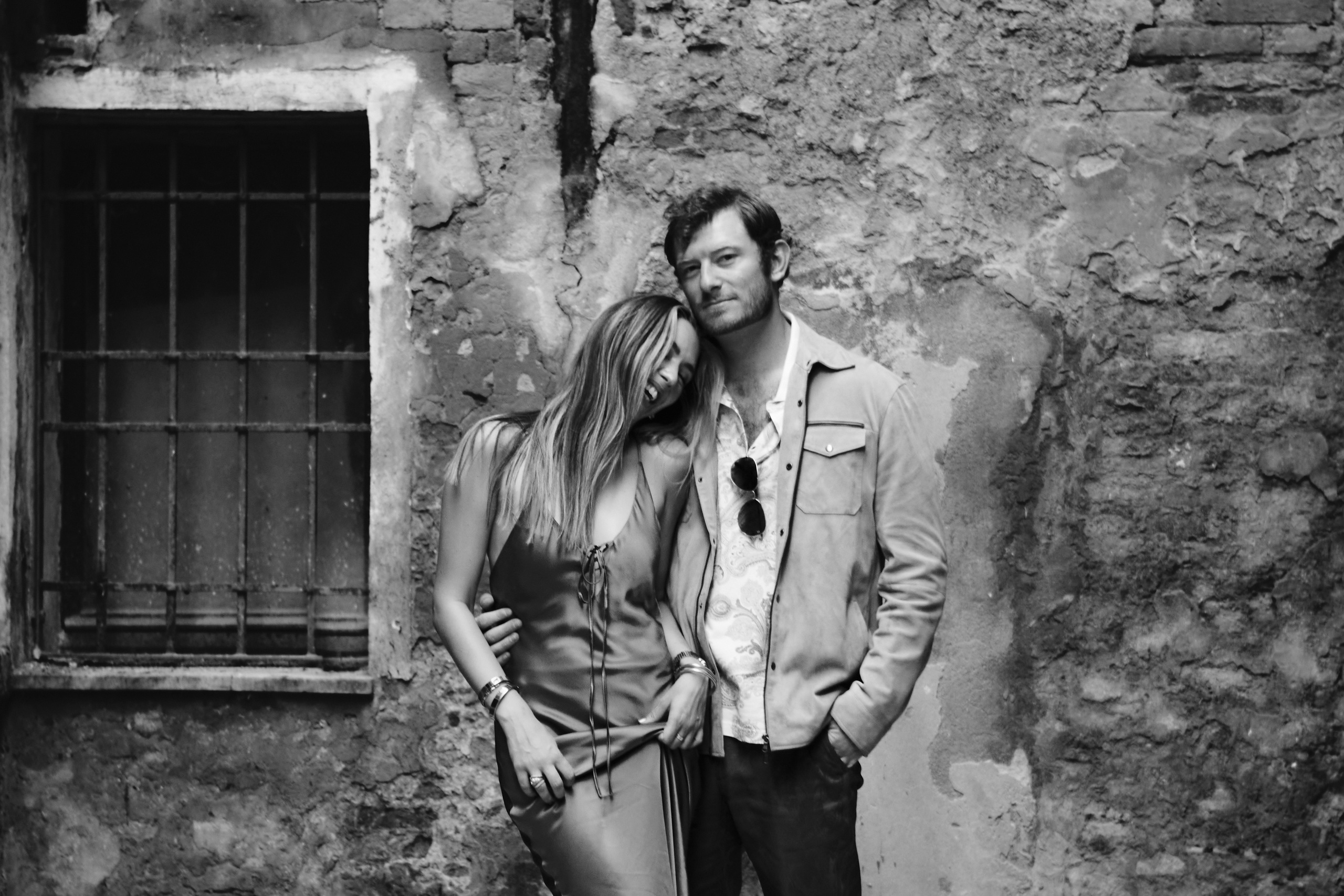 black and white photo, With each click of the camera, the love and laughter of this couple become everlasting memories. These photographs will serve as a visual testament to their happiness, a reminder of the special moments they shared during their time in Venice.
