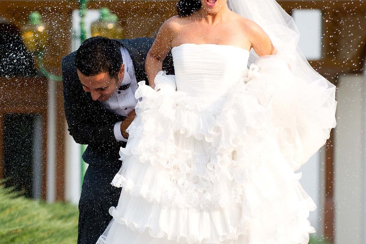 Wedding photography session Snagov Palace, Bucharest Romania. Wedding photographer Nikon D850 Couple running through garden sprinklers