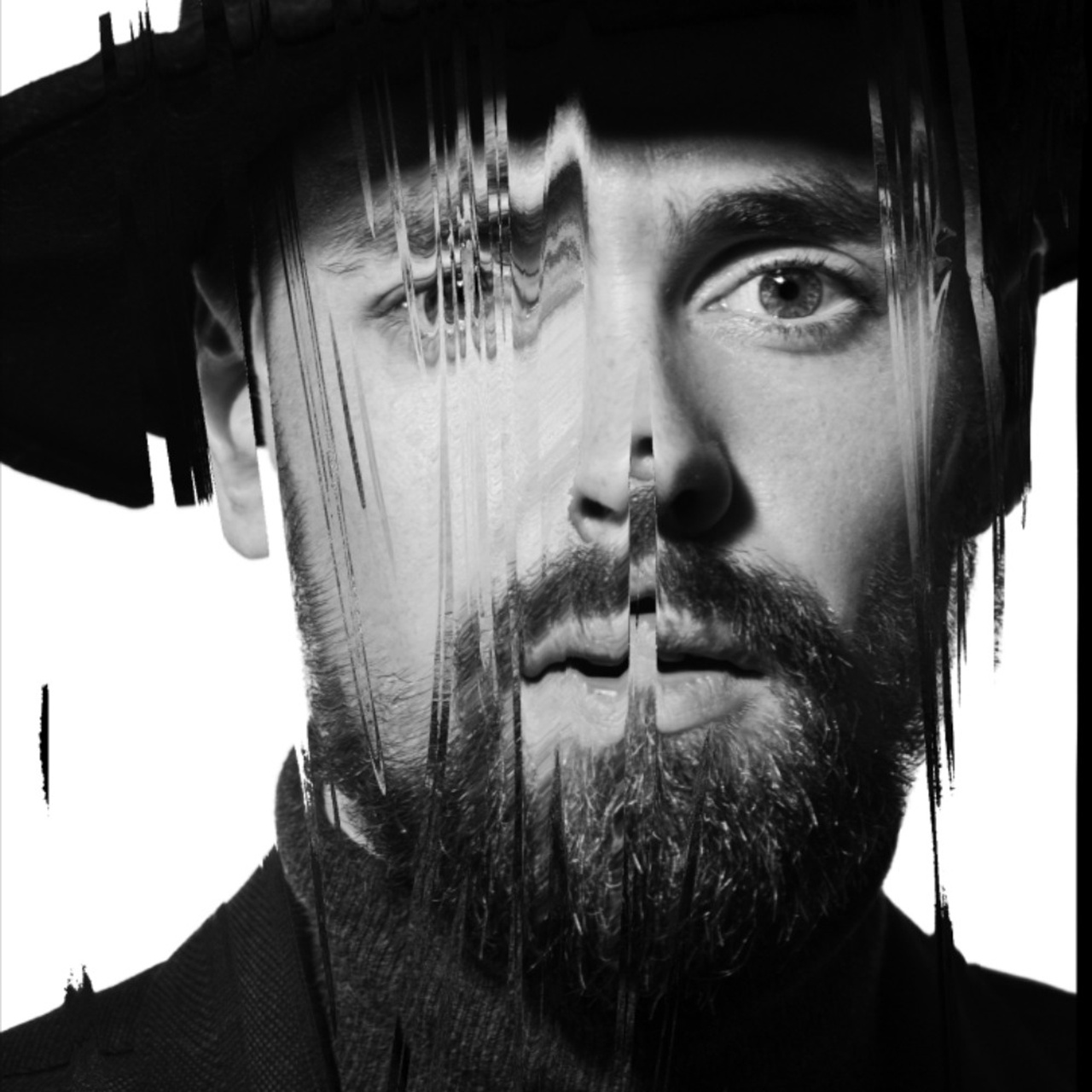 A photographer's abstract black and white study of a man's face, with digital distortion blurring and stretching features, creating a thought-provoking visual effect