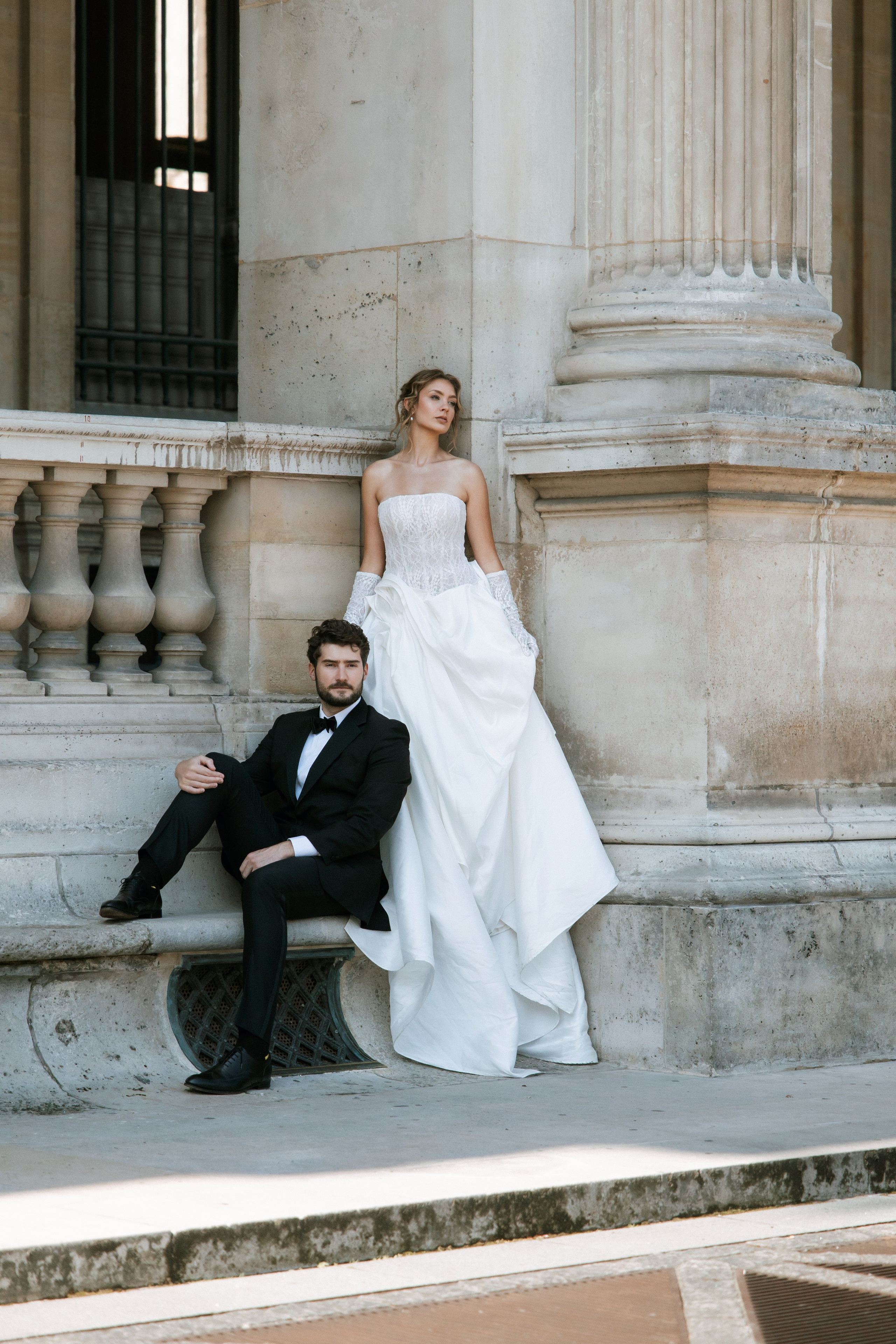 Bride and groom walking through romantic Paris street with soft morning light and elegant editorial styleTimeless Paris elopement photo with bride holding bouquet in golden hourCouple kissing in front of Eiffel Tower – luxury wedding photography in Paris