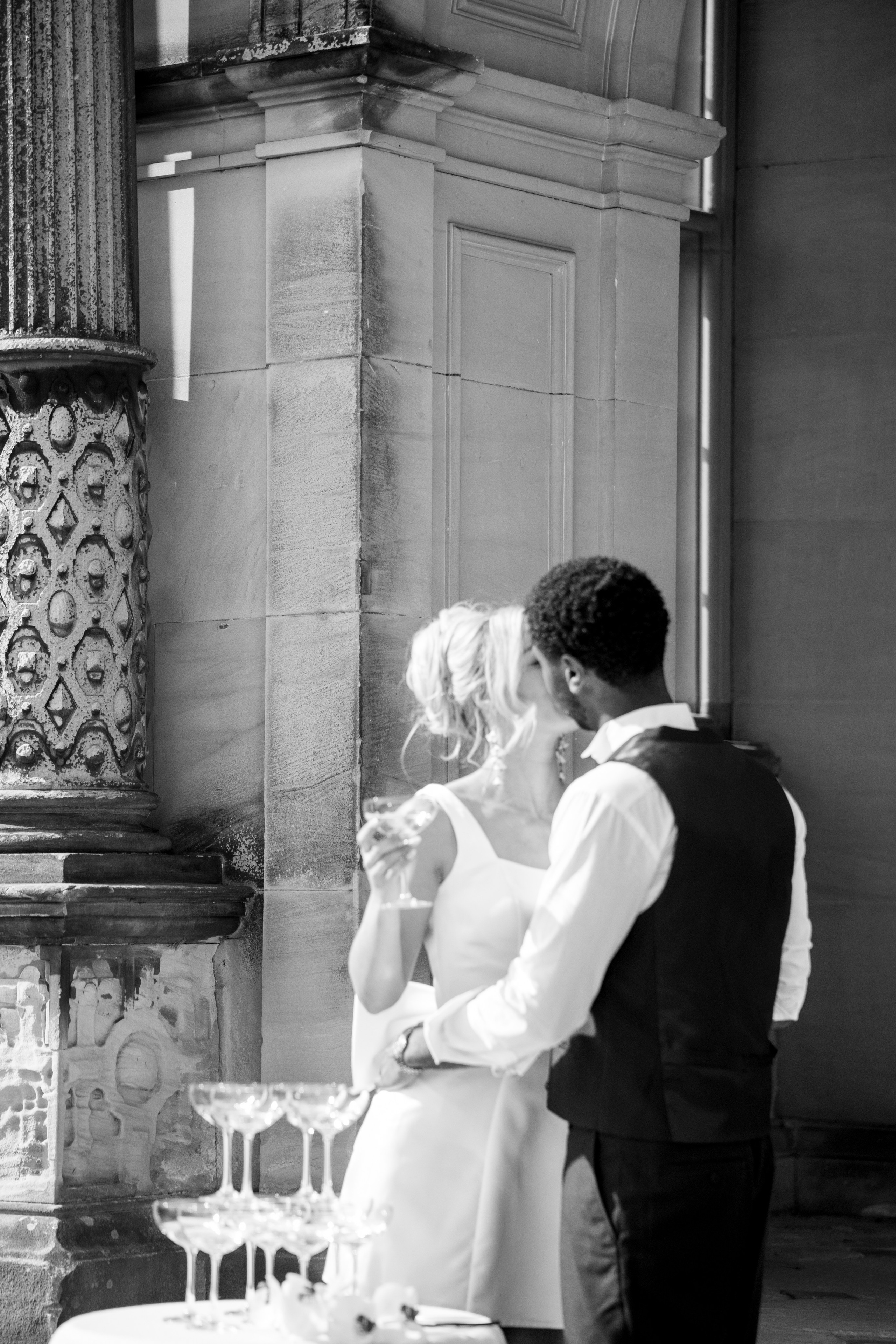 Modern bride and groom in London streets near Marylebone Town HallCandid editorial moment of couple laughing outside Home House wedding venueStylish couple on London steps – timeless black and white wedding portrait