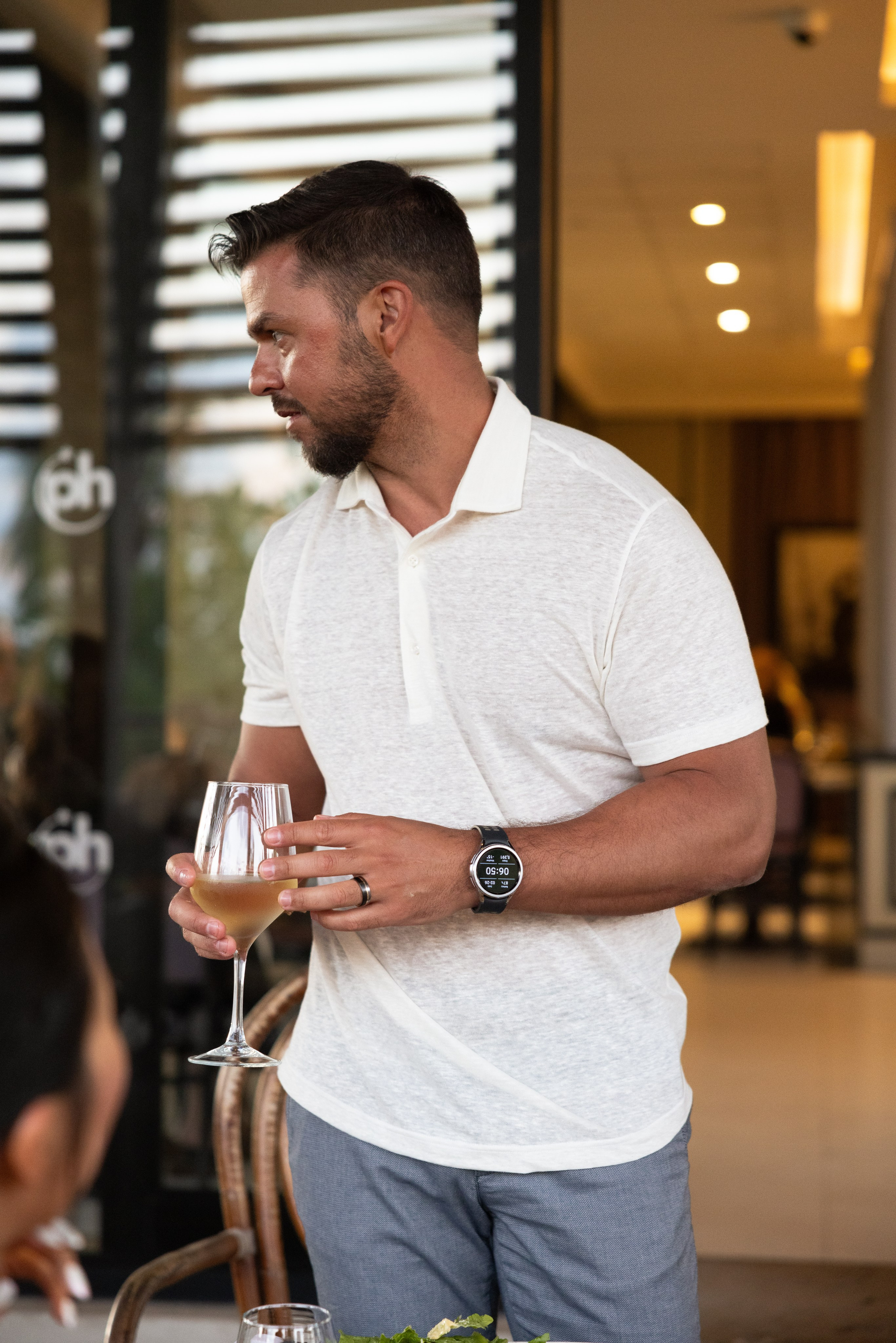 Groom raising a glass while giving a toast during pre-wedding dinner at Planet Hollywood Cancun.