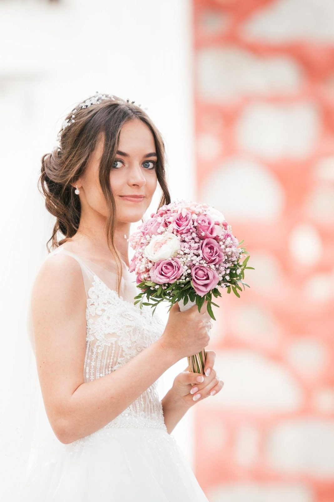 A beautiful bride in a wedding dress holding a bouquet.