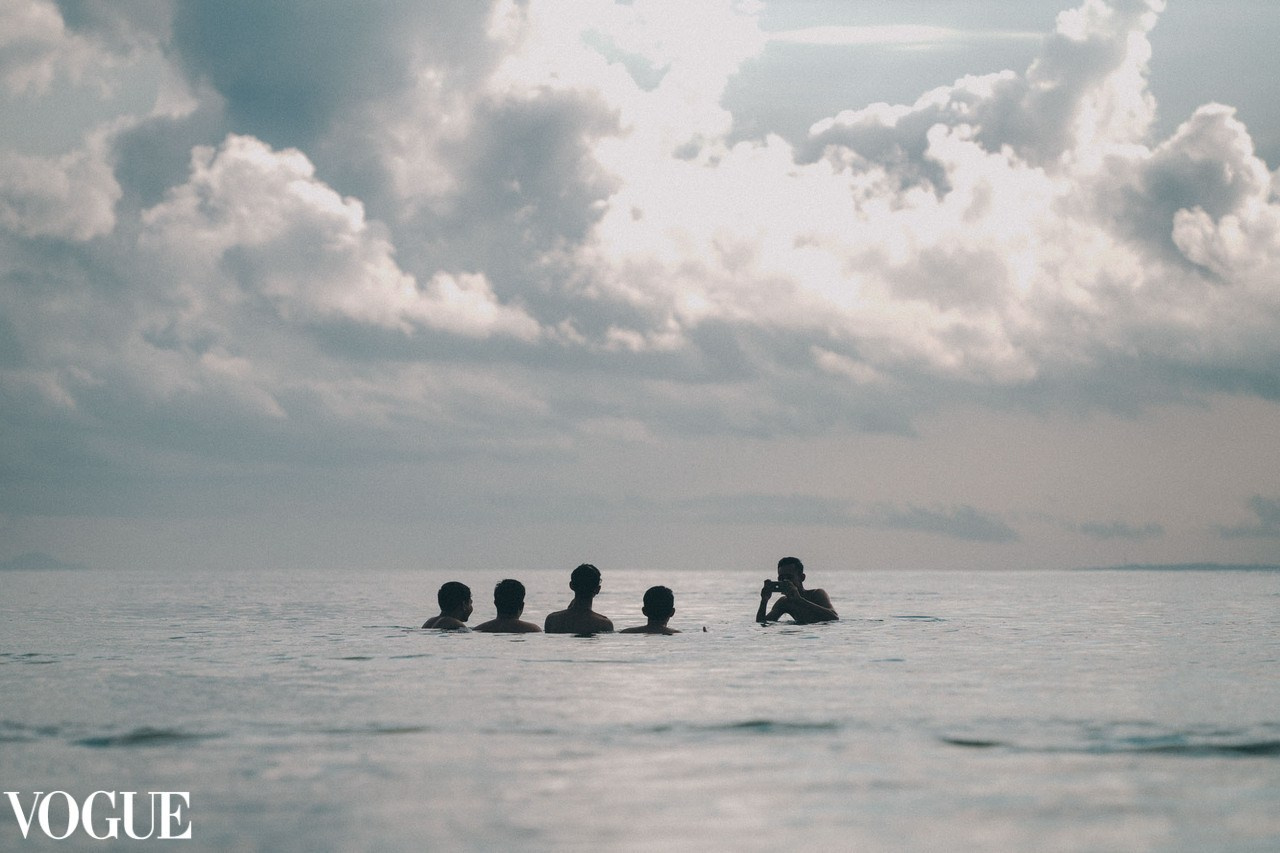 Bali kids taking photo in the sea.