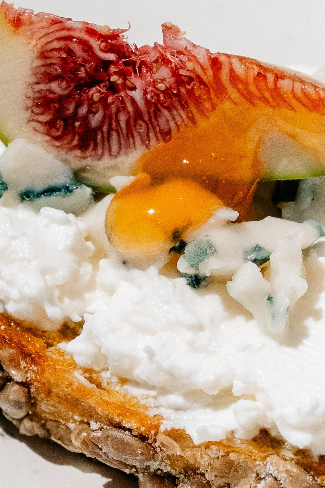 Cheese and fig open sandwich with a honey drop. Maria Sher. Professional photographer from Porto, Portugal