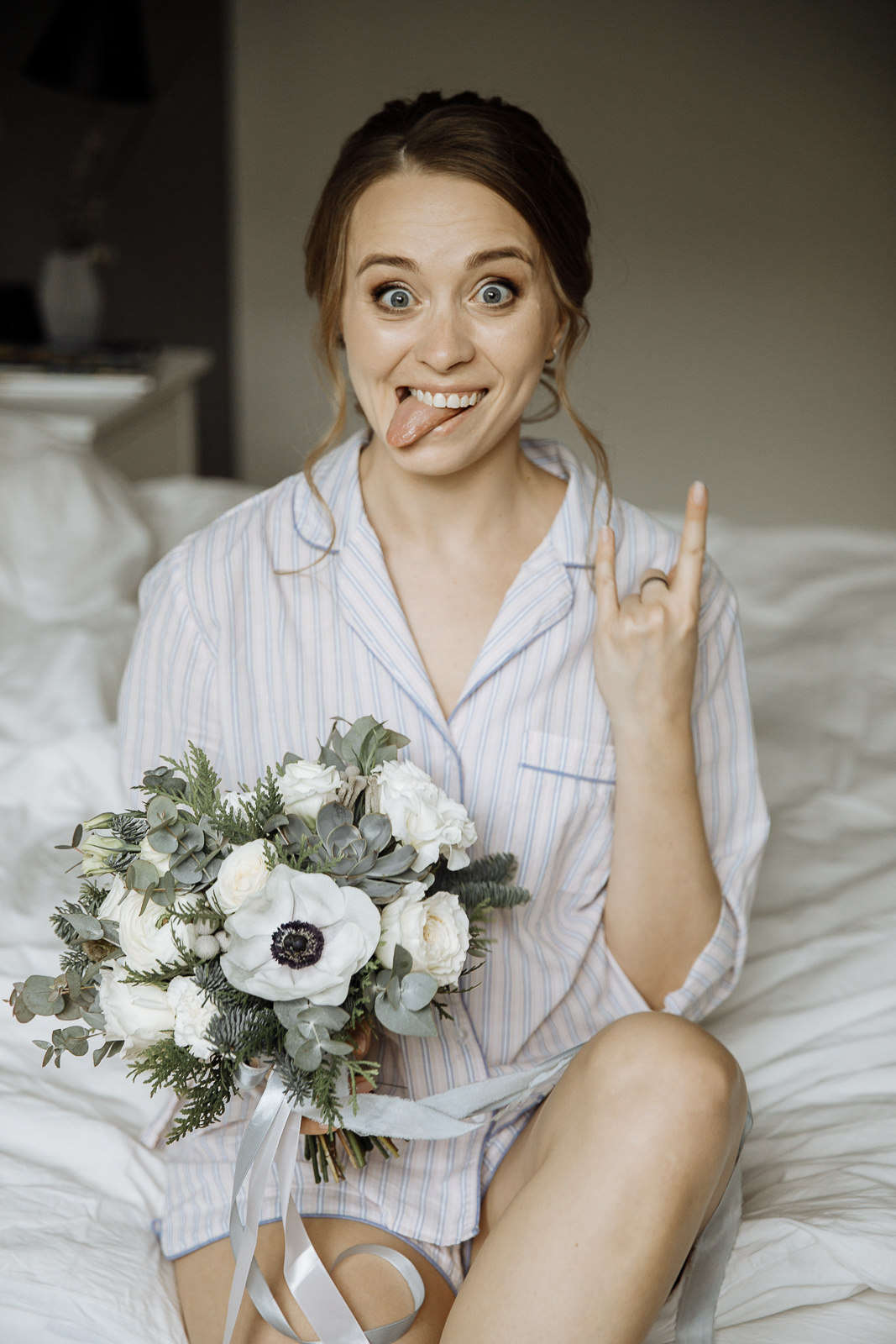 Bride sticking out tongue holding bouquet, by Tanya Bogdan, Plymouth wedding photography.  